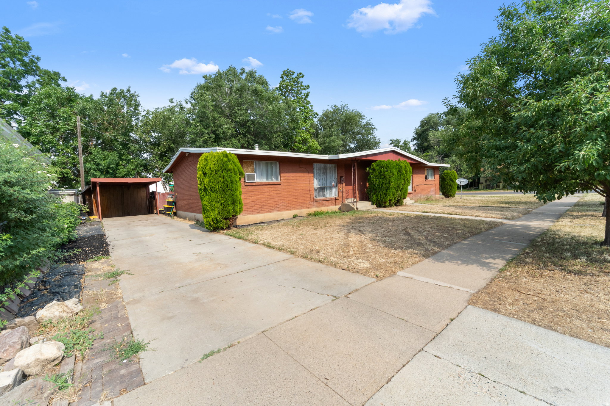 Brick exterior with a covered carport