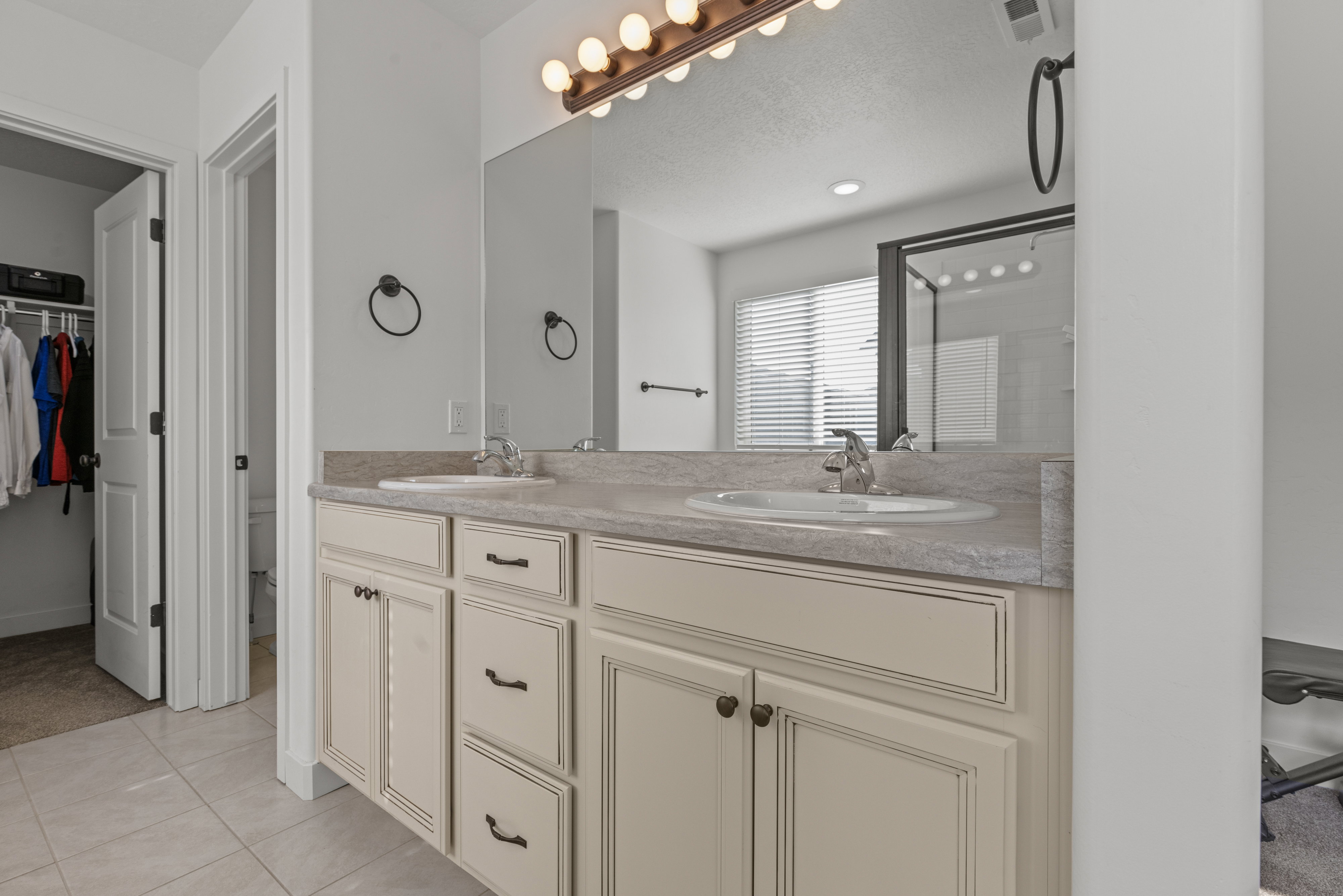 Double vanity with undermount sinks and light-toned cabinetry