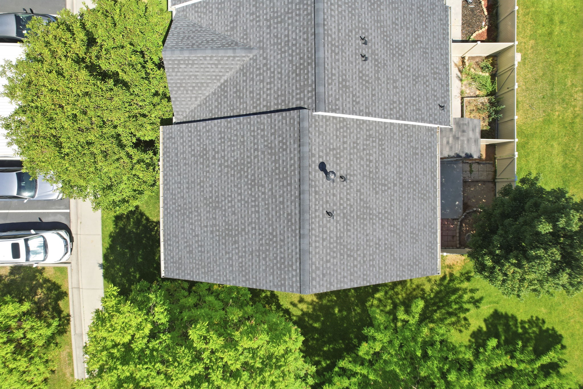 Grey shingle roof featuring a visible ridge line and multiple vents