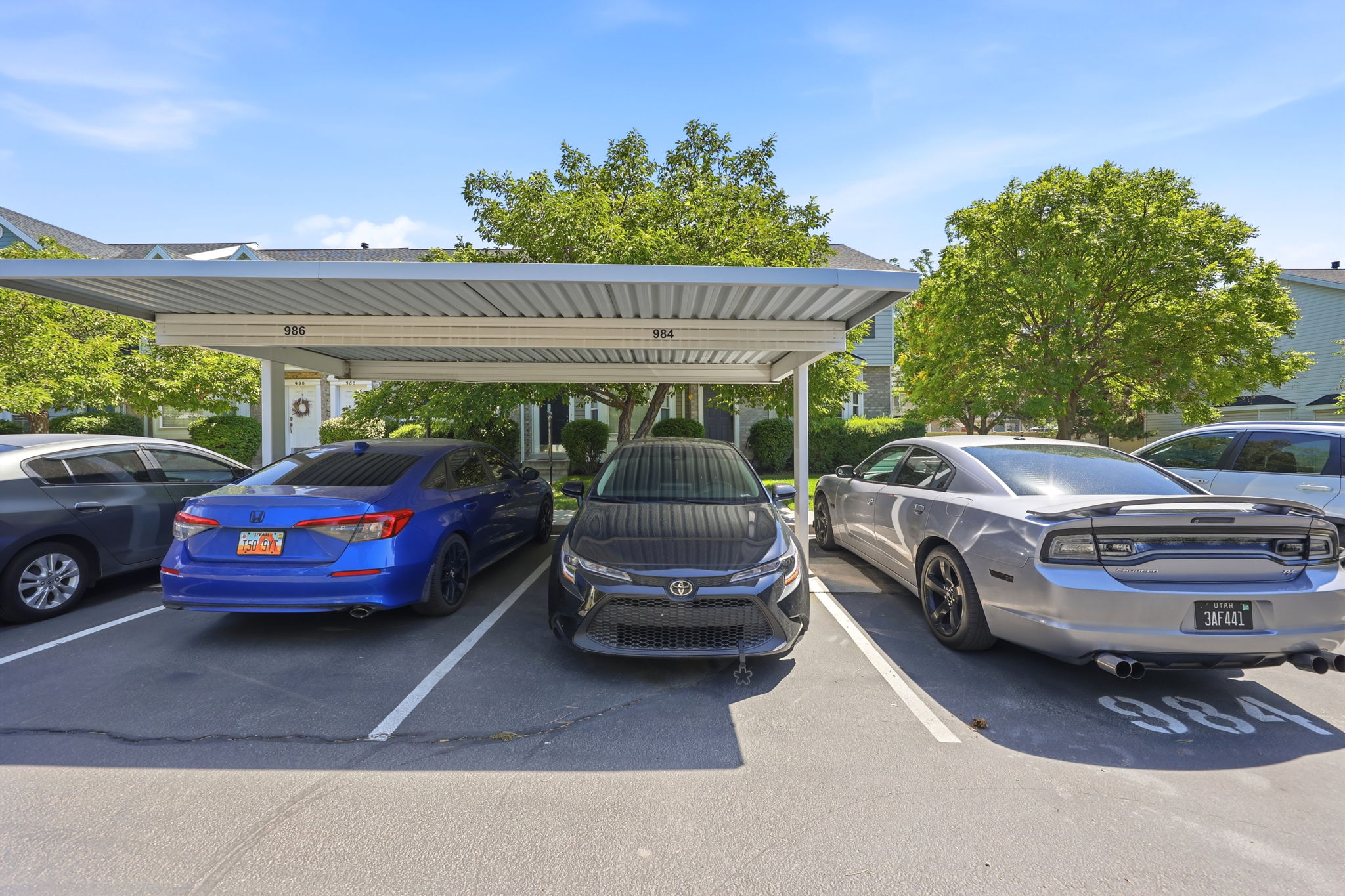 Covered parking structure featuring numbered spaces and a metal roof
