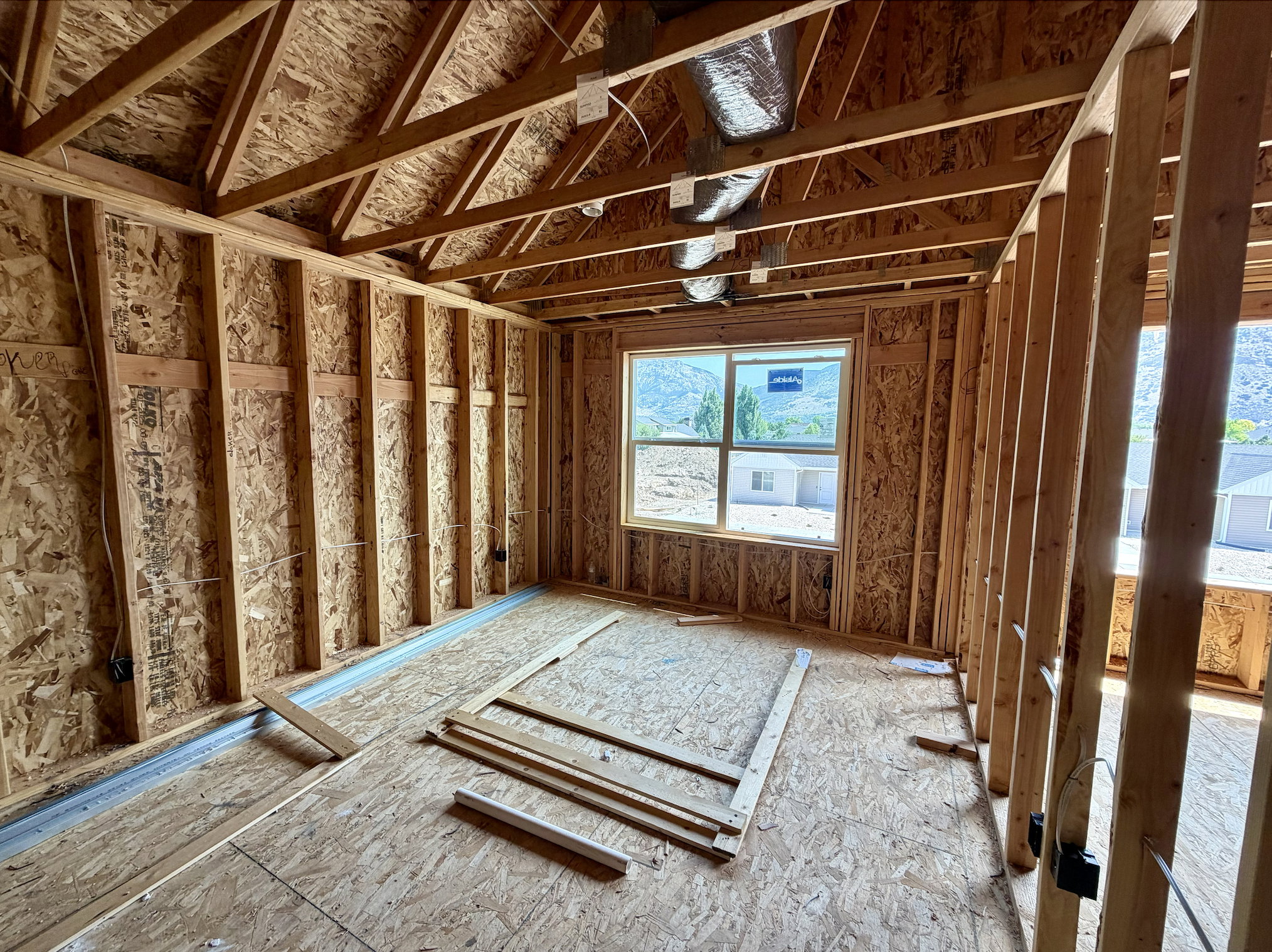 Interior framing showcasing exposed wood studs and ceiling joists