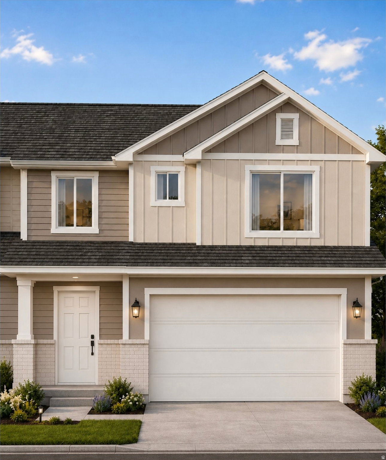 Two-story residence featuring a two-car garage, partial brick veneer, and a multi-gabled roofline