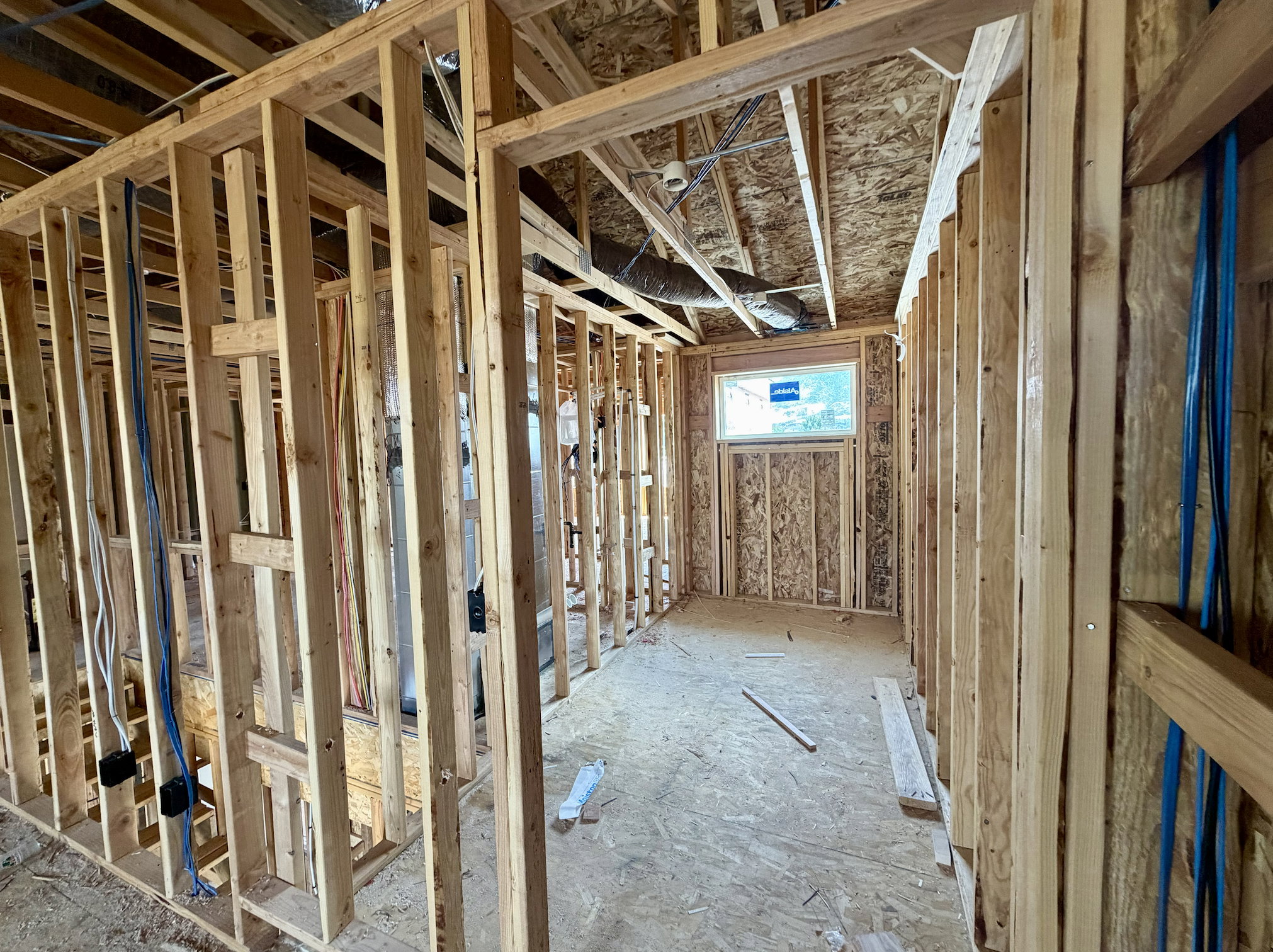 Interior framing showcasing wooden studs and OSB sheathing
