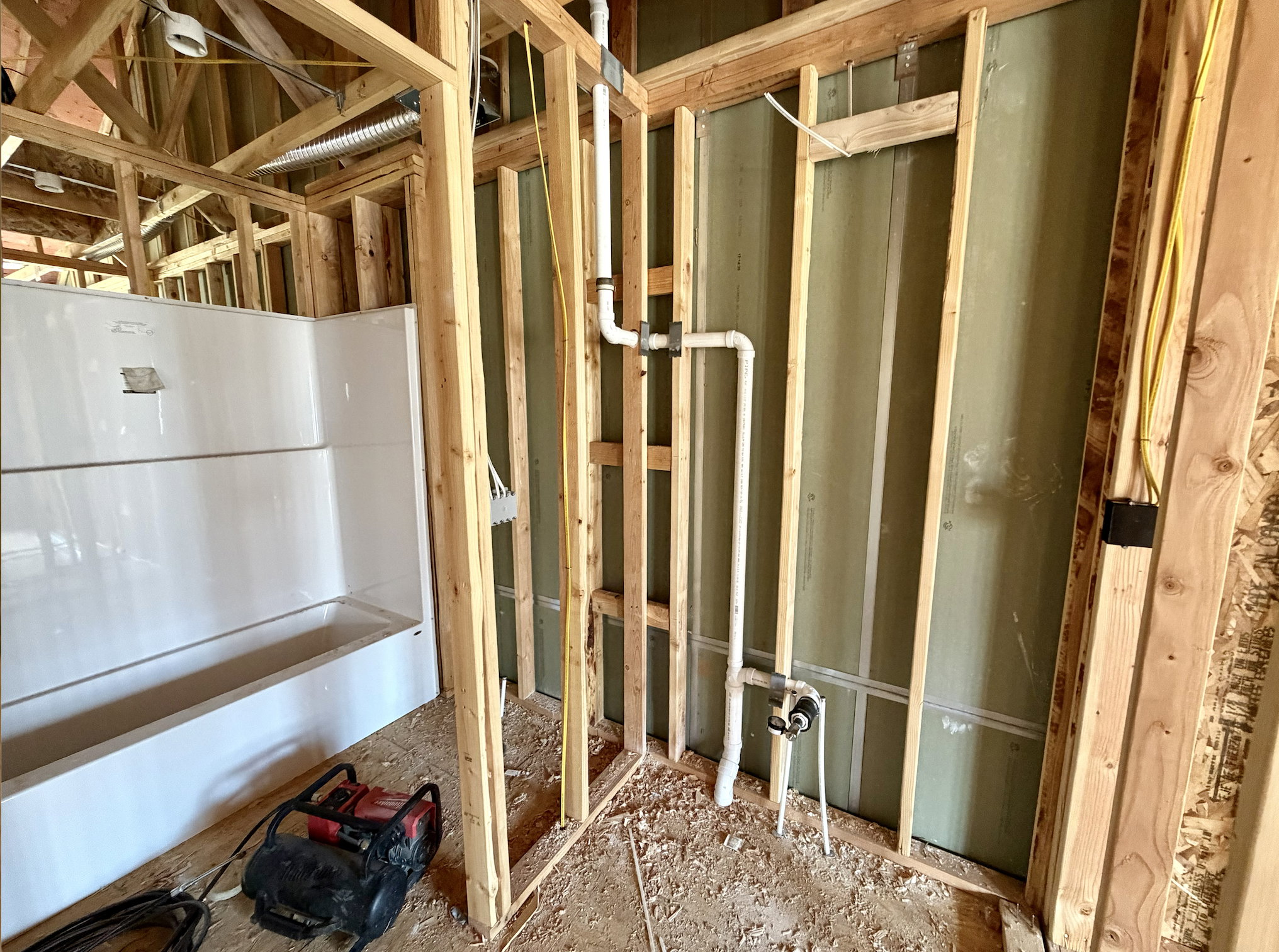 New construction framing with visible plumbing rough-in