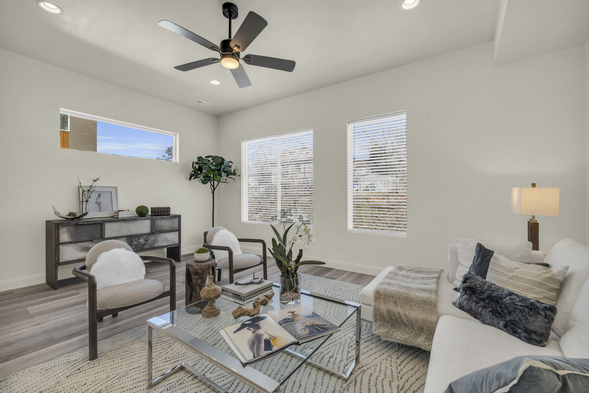Spacious living area featuring wood-finish flooring, recessed lighting, and a modern ceiling fan