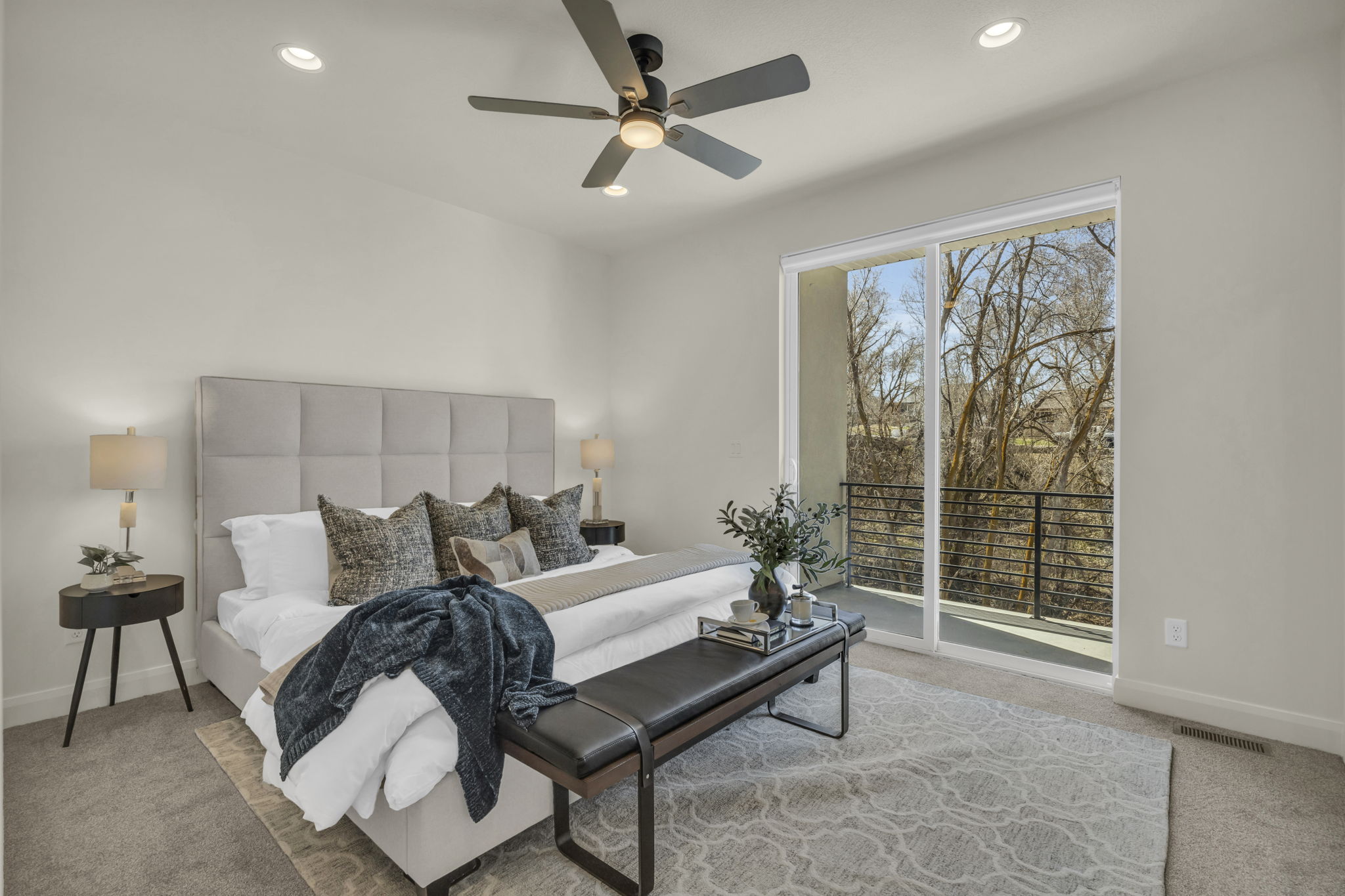 Spacious room featuring a sliding glass door to a private balcony with a metal railing