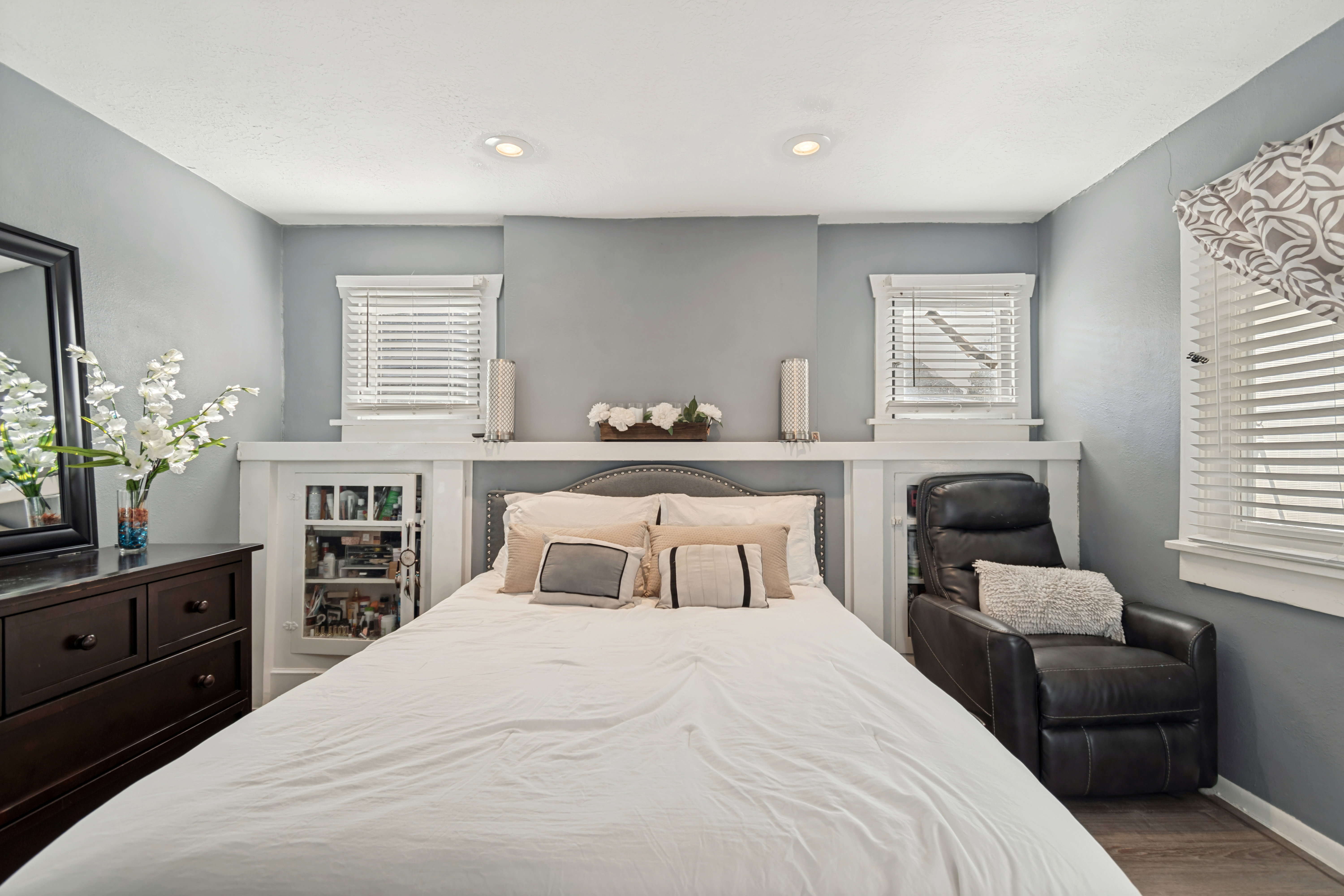 Bedroom featuring light gray walls and wood-finish flooring