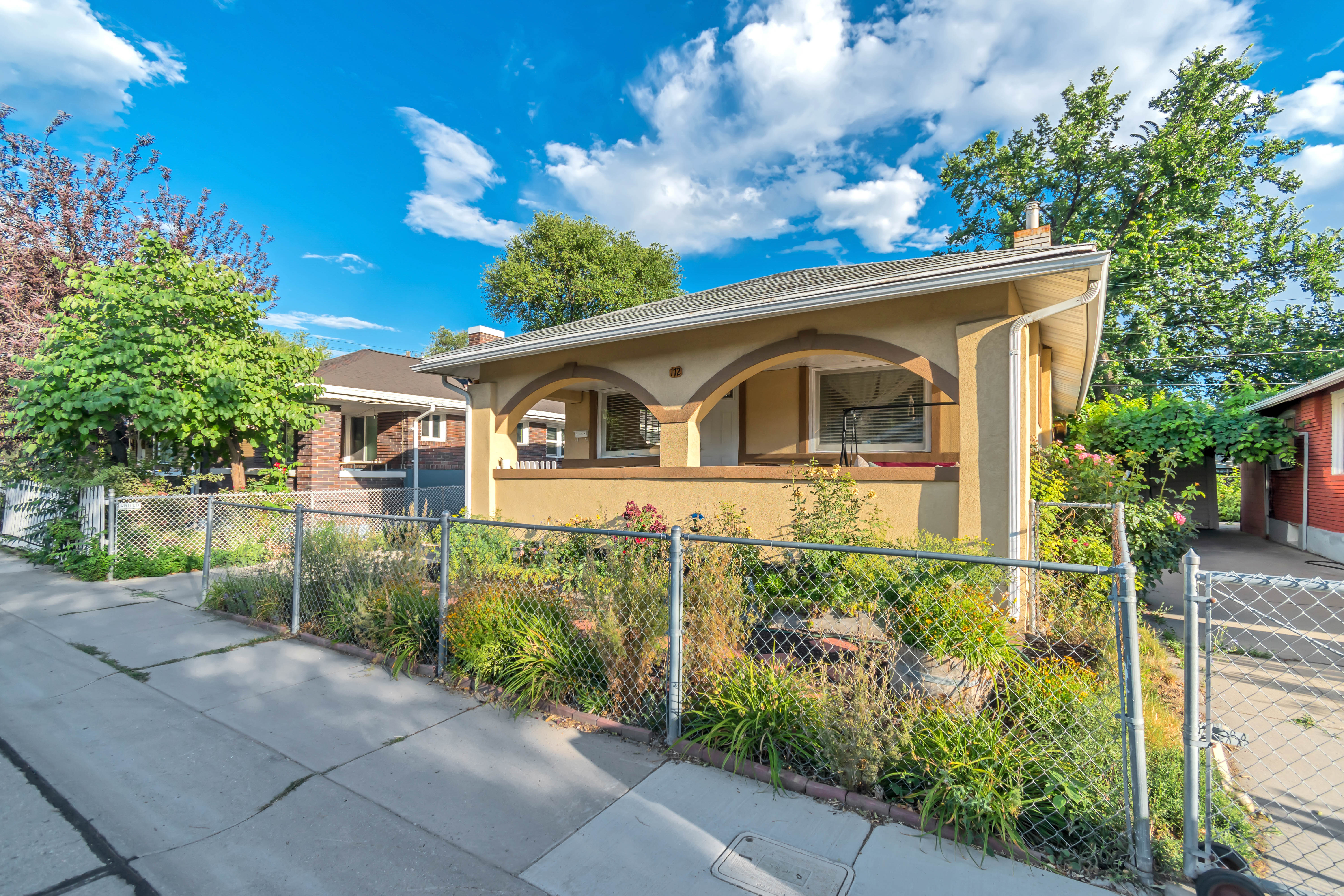 Single-story residence featuring a covered entry porch with arched detailing