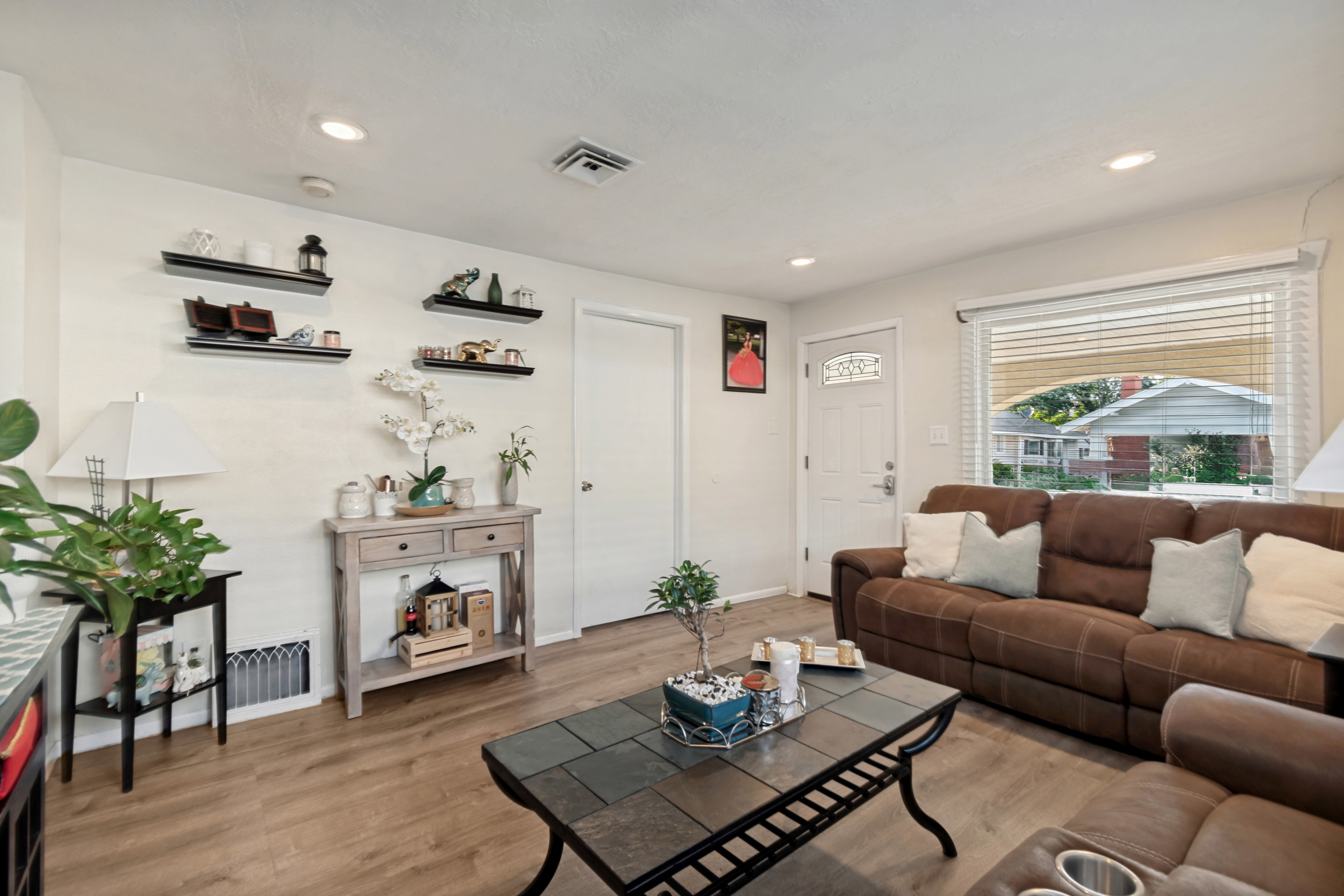 Living space featuring wood-finish flooring, recessed lighting, and a front entry door with decorative glass
