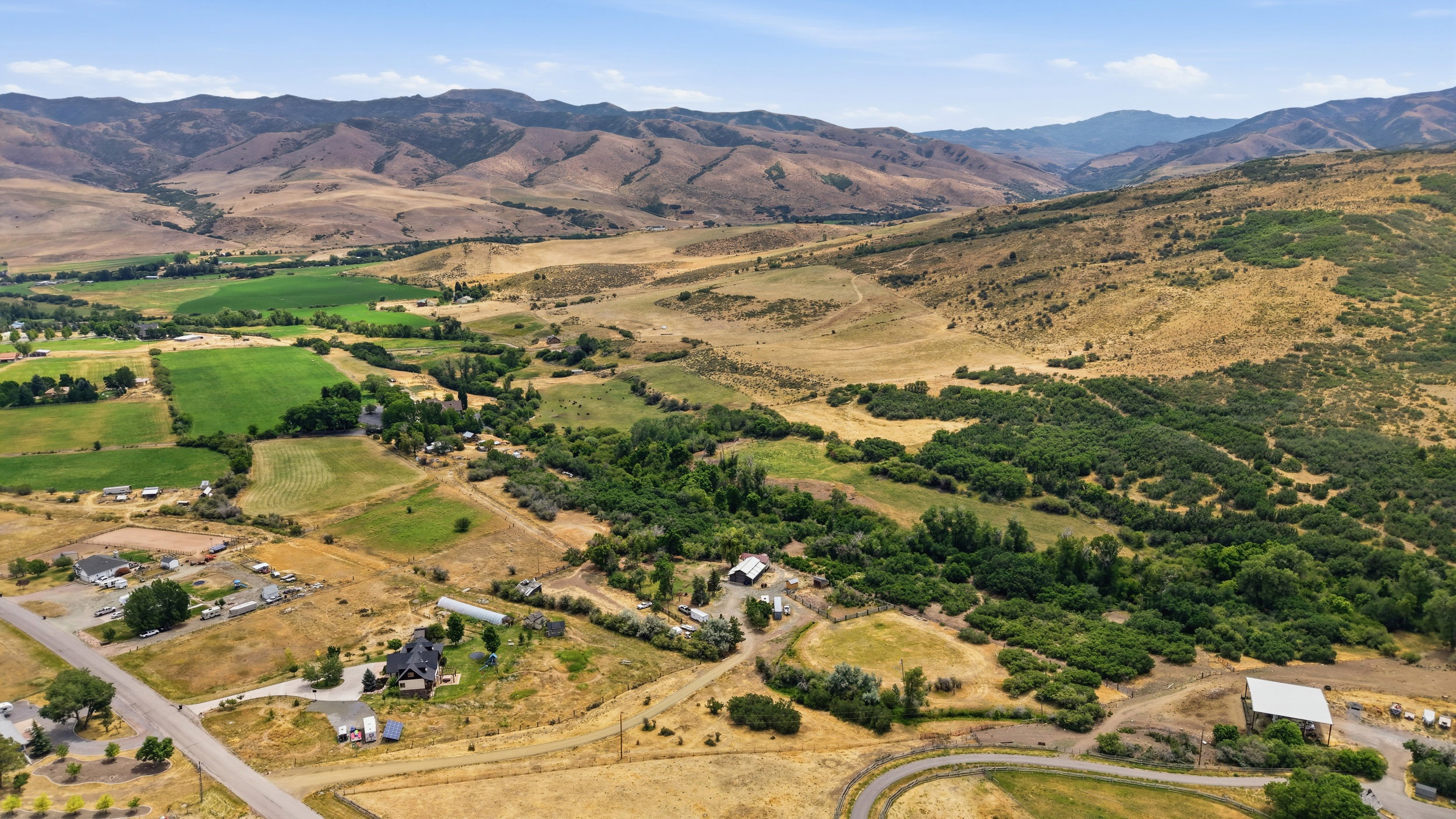 Expansive property featuring rolling hills, varied terrain, and distant mountains