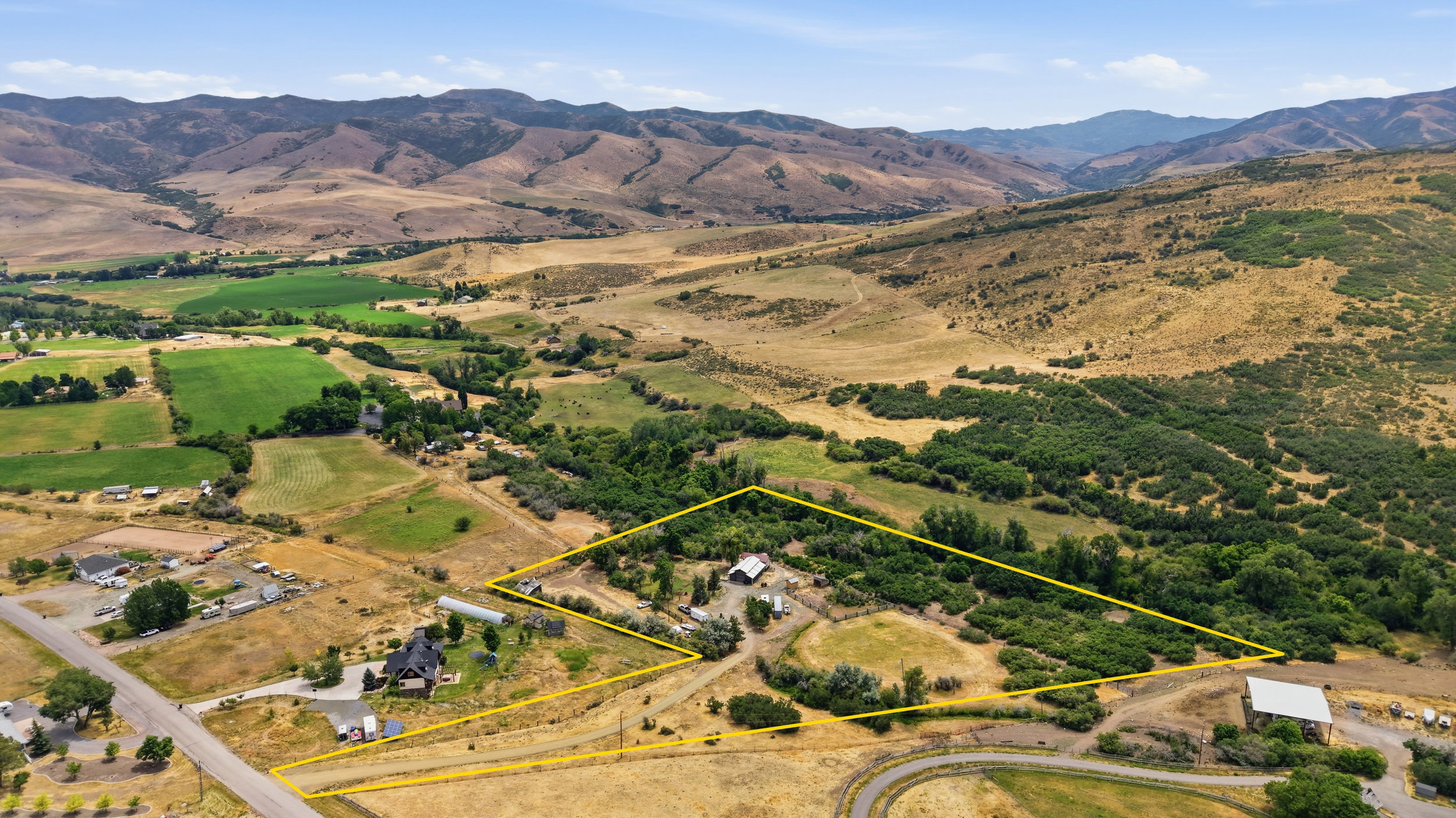 Expansive property featuring a mix of cultivated fields and natural vegetation