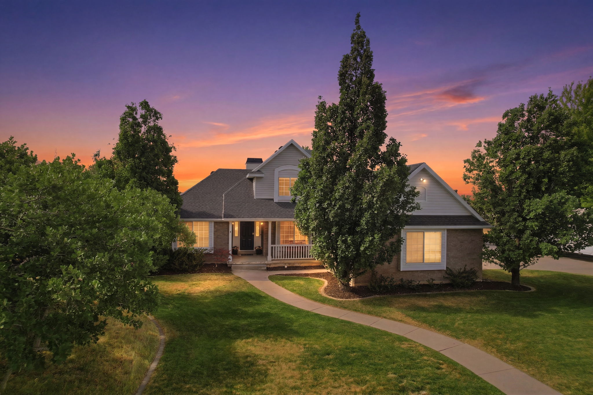 Traditional-style residence featuring a brick and siding exterior