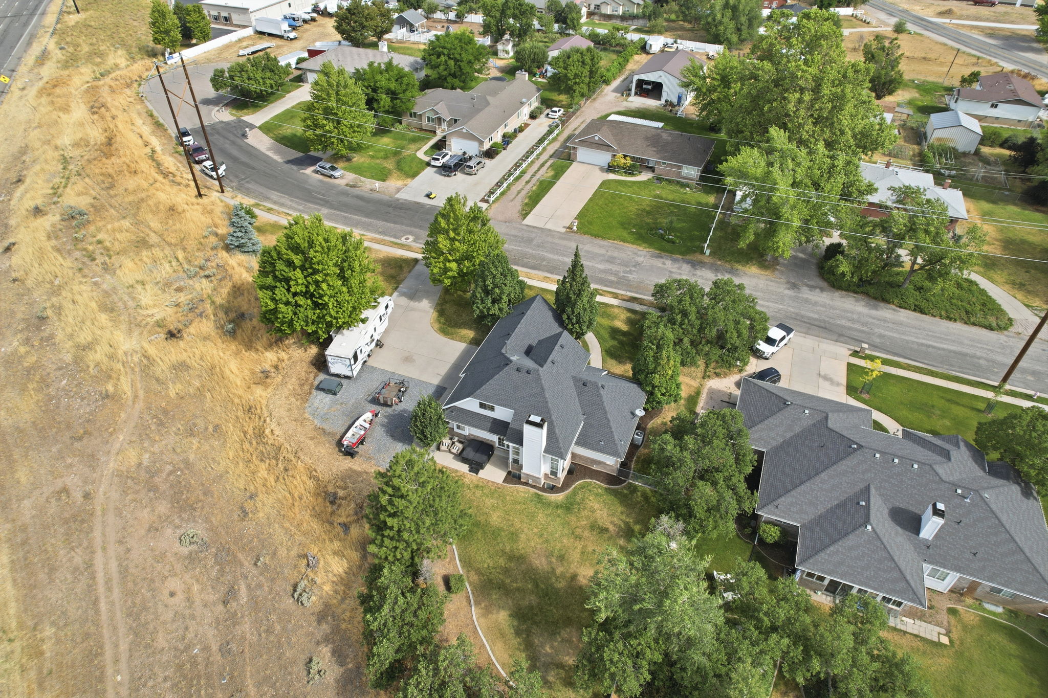 Two-story residence featuring a multi-gabled roofline and multiple chimneys