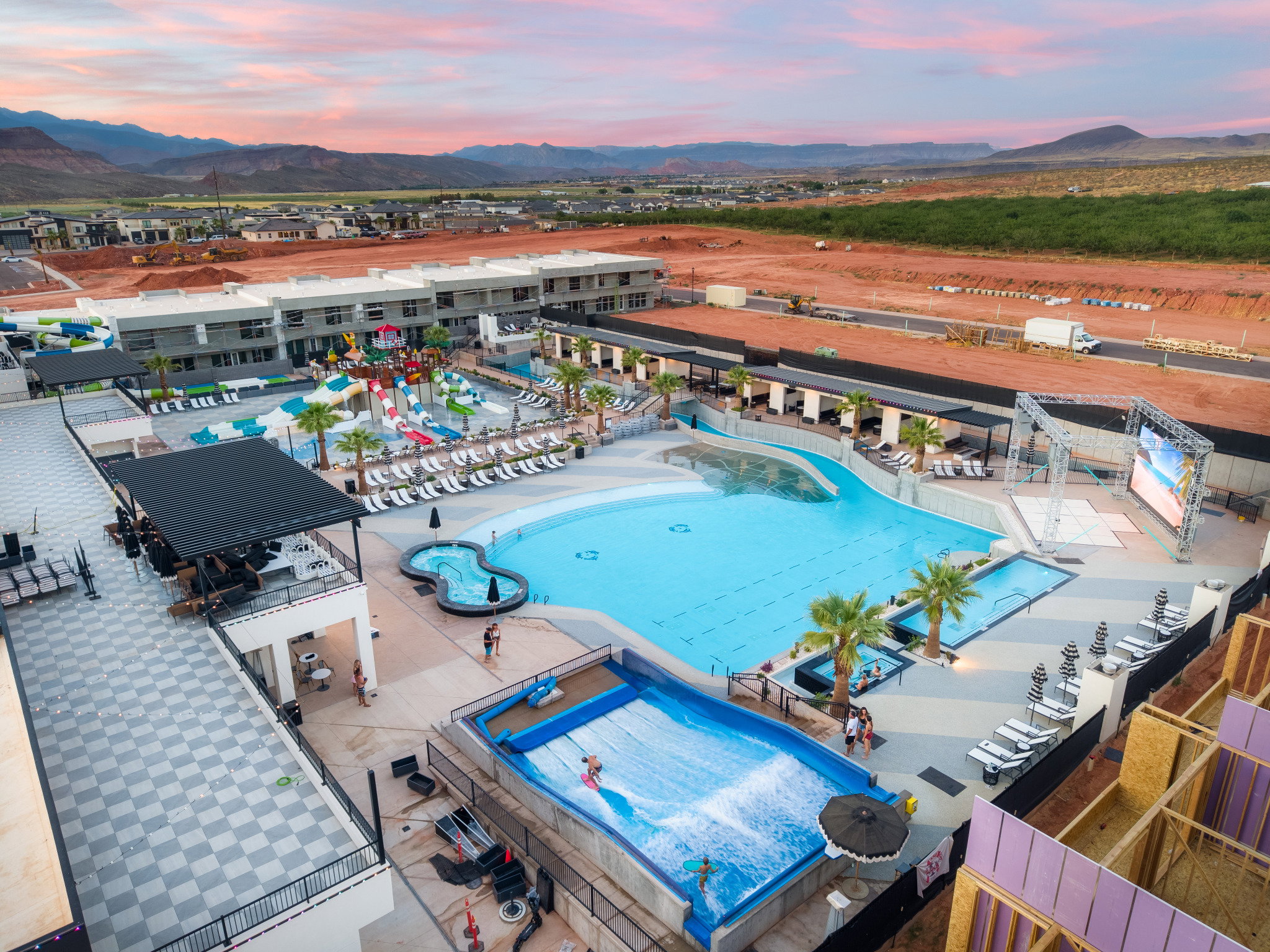 Expansive aquatic facility featuring a wave pool, additional swimming pools, and multiple water slides