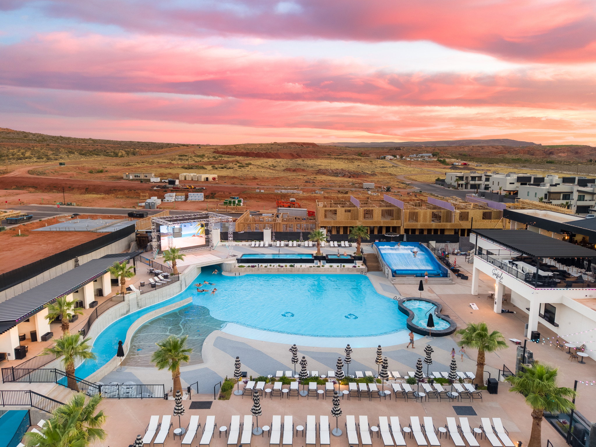 Expansive resort-style swimming pool featuring a meandering water slide, tanning ledge, and integrated spa