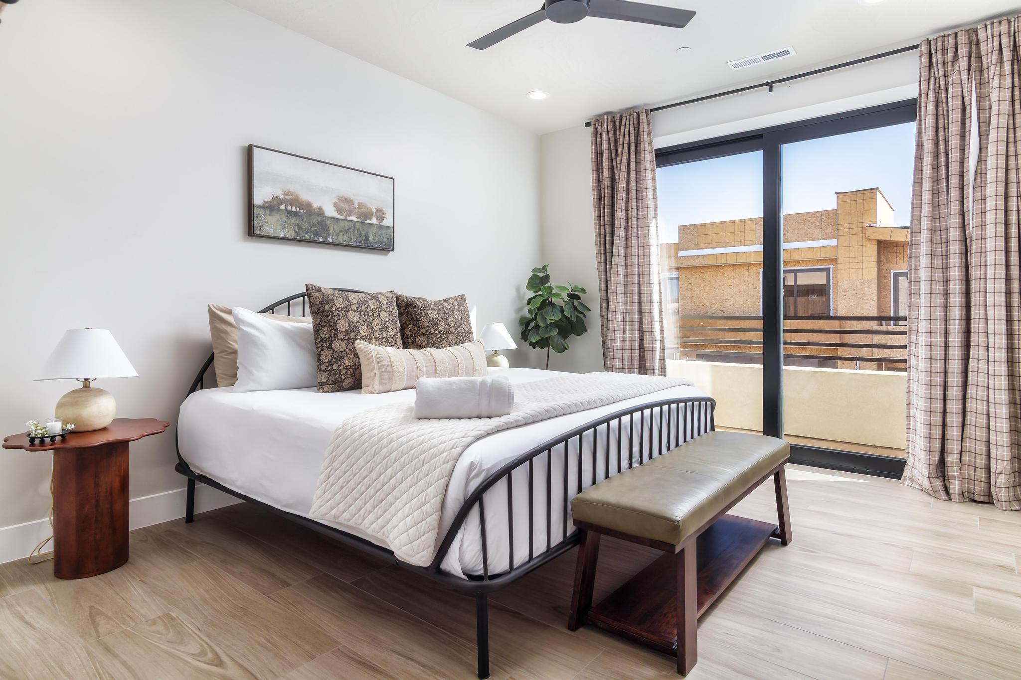 Bedroom featuring wood-finish flooring, a contemporary black ceiling fan, and recessed lighting