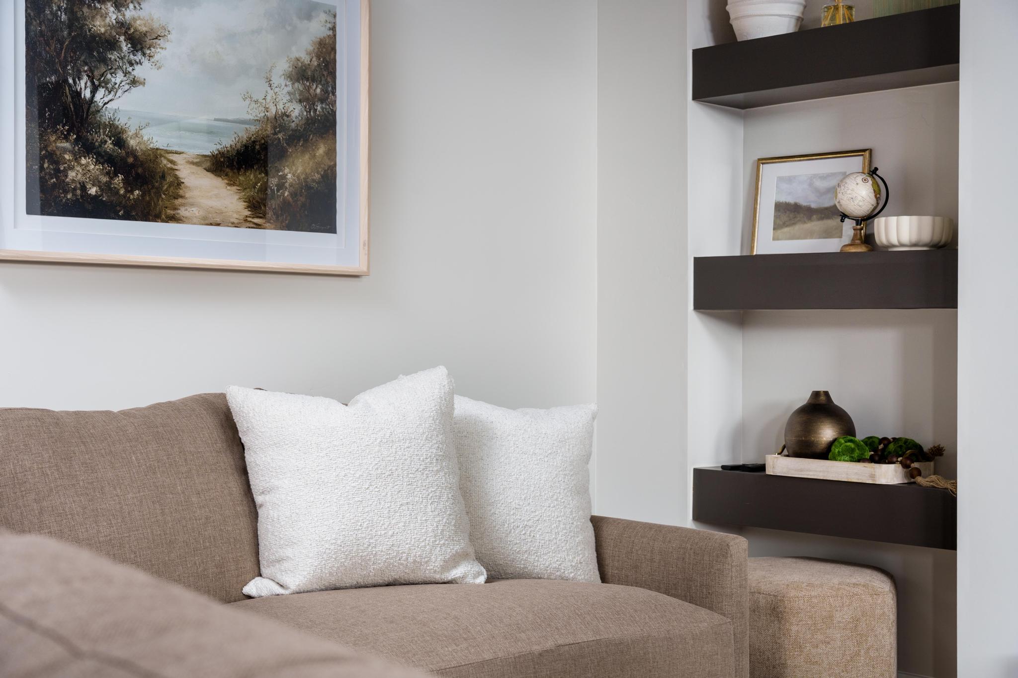 Built-in shelving with a dark wood finish provides storage and display space