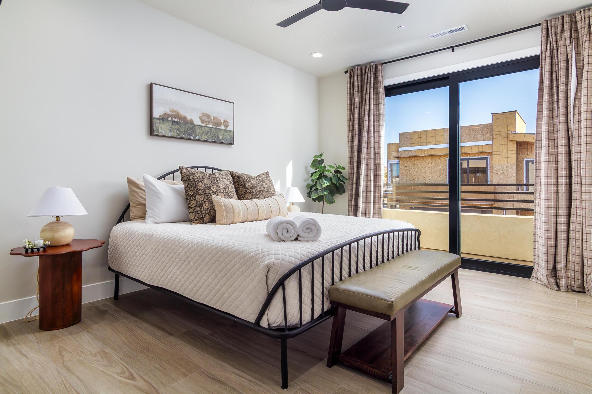 Expansive sliding glass doors open to a private balcony