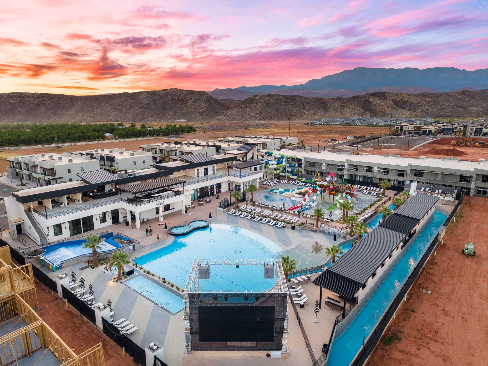 Expansive resort-style amenity area featuring a large central pool, multiple additional pools, and a water park