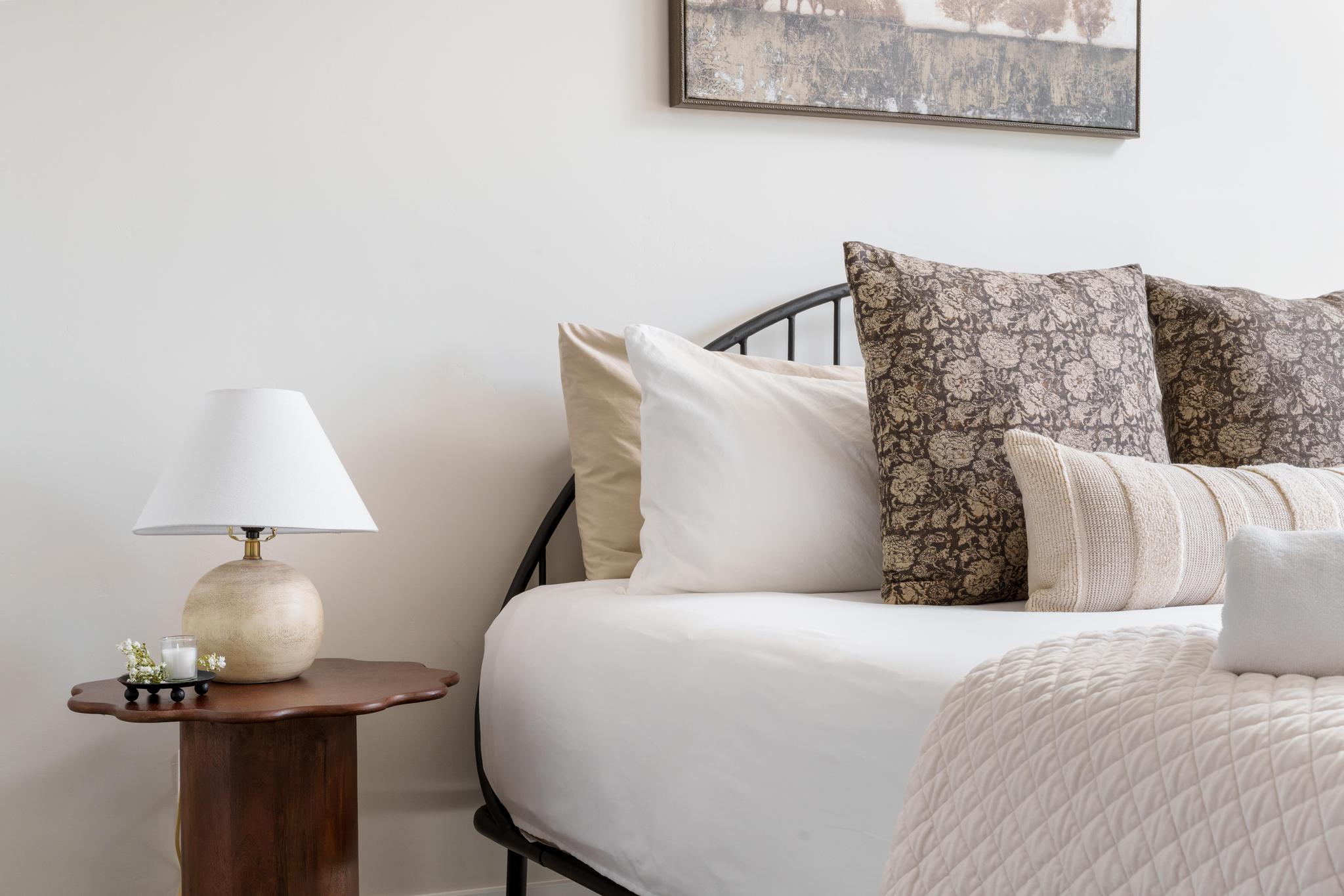 Neutral wall tones with a dark wood-finish side table