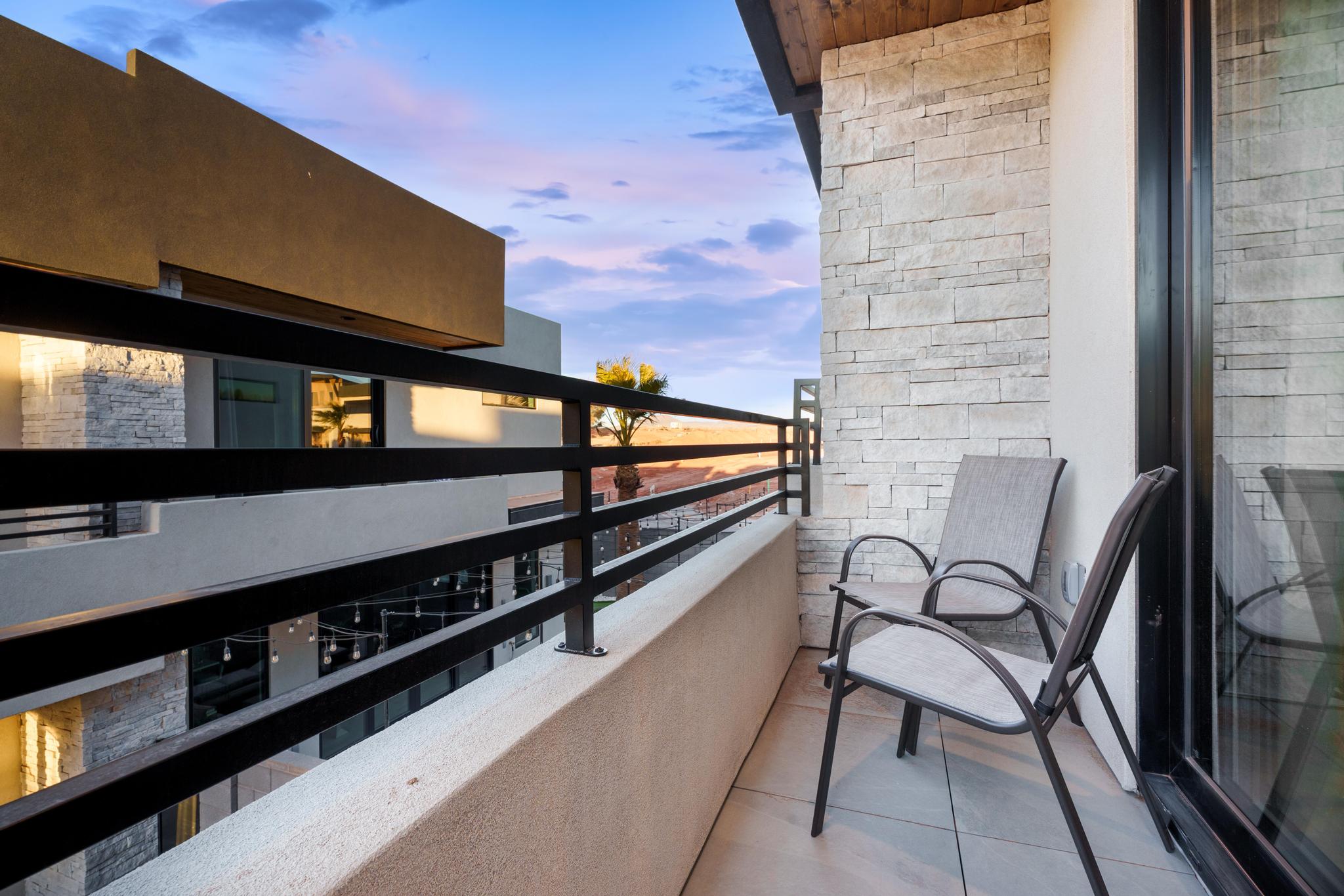 Private balcony with tile flooring and a black metal railing