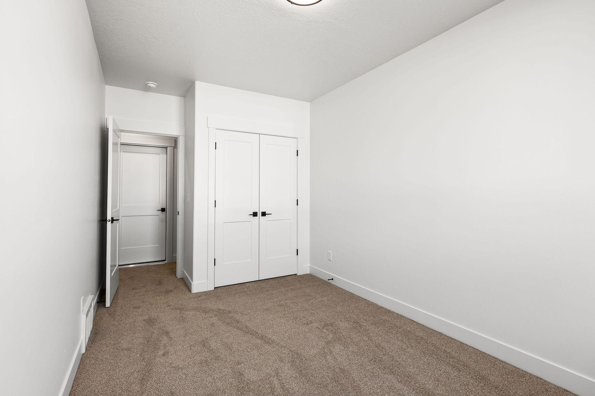 Neutral-toned carpeting complements bright white walls and trim