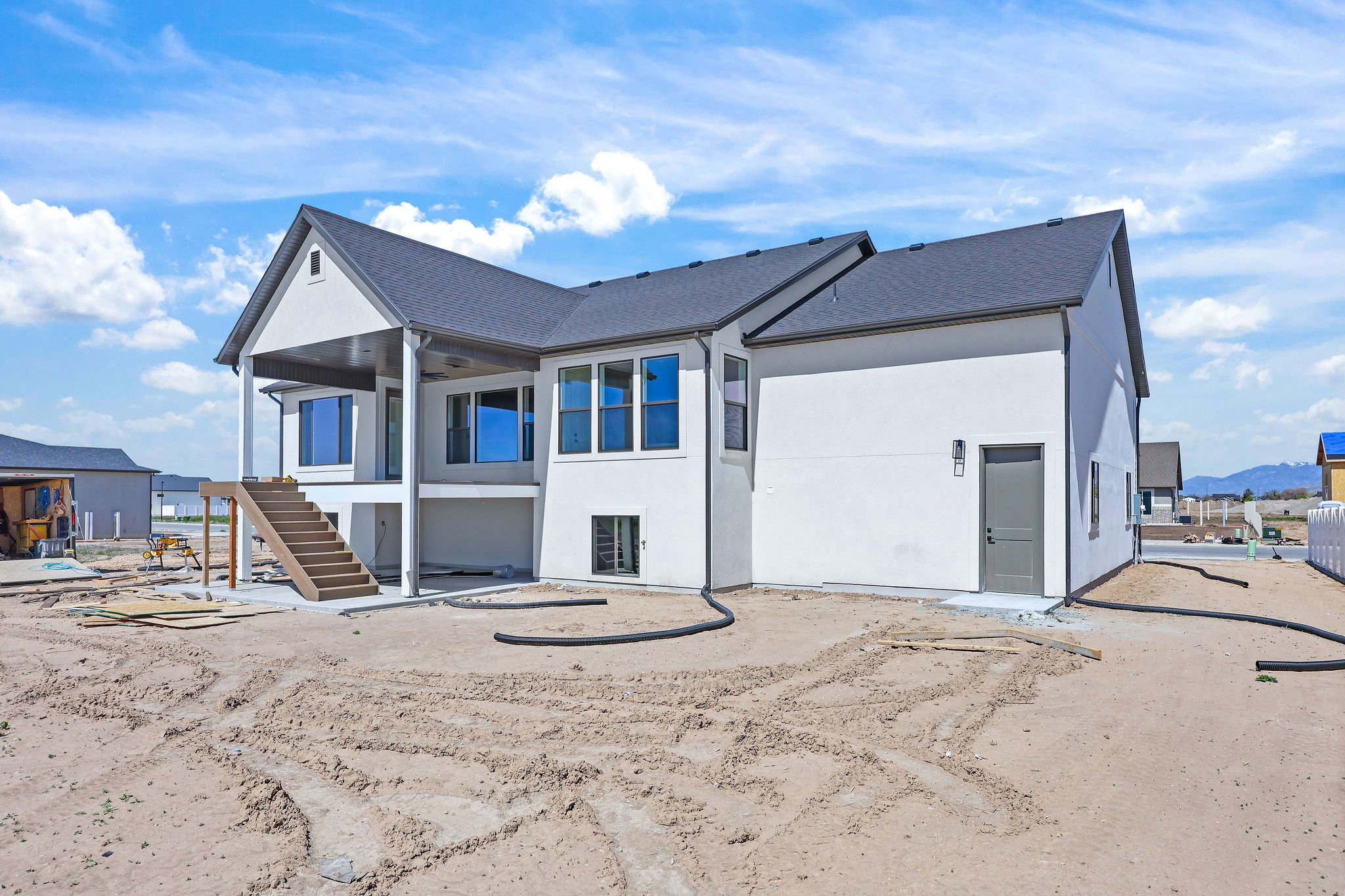 Modern exterior facade with a covered patio and an exterior staircase