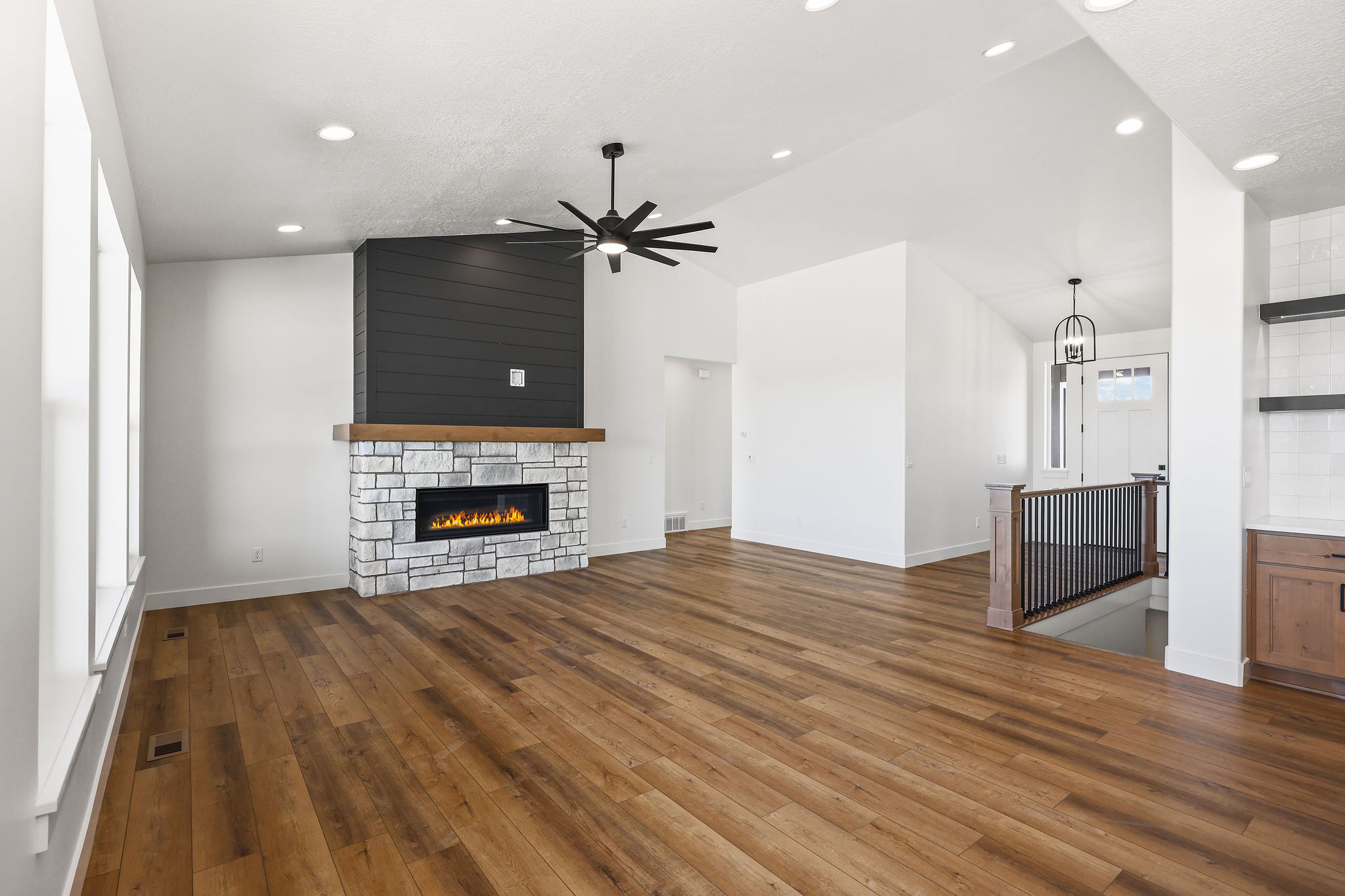 Spacious interior featuring wood-finish flooring and recessed lighting