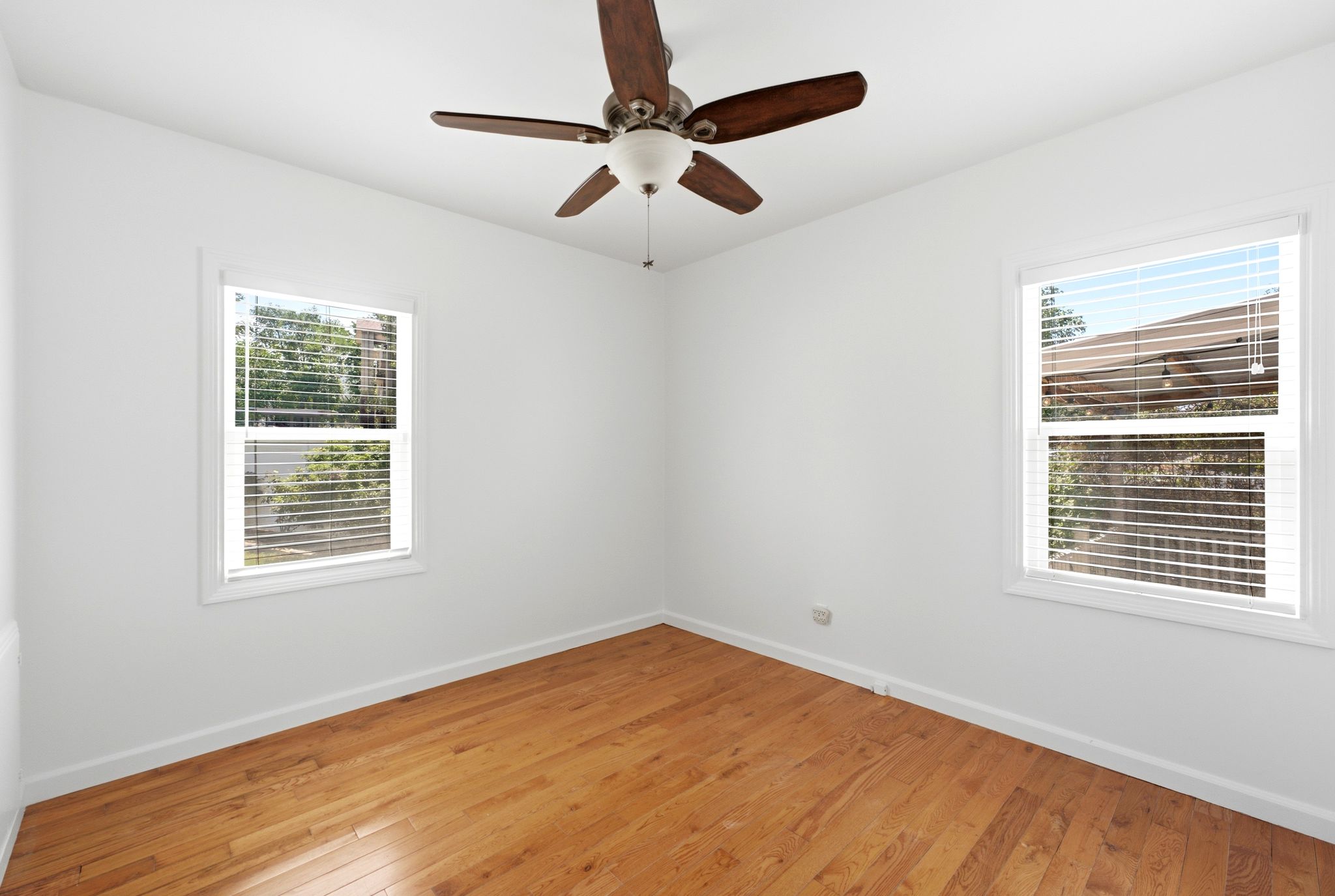Interior space featuring wood-finish flooring and white baseboards