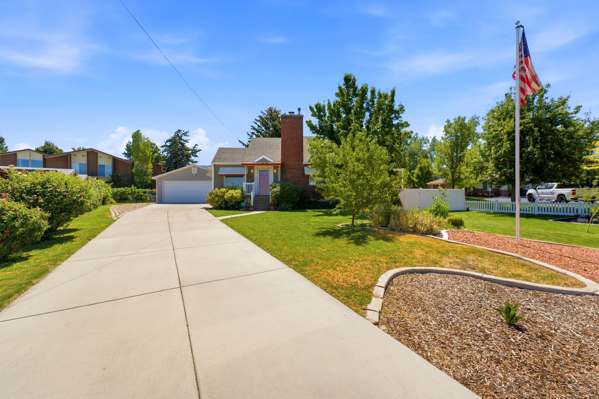 Single-story residence featuring a brick chimney and a covered front porch