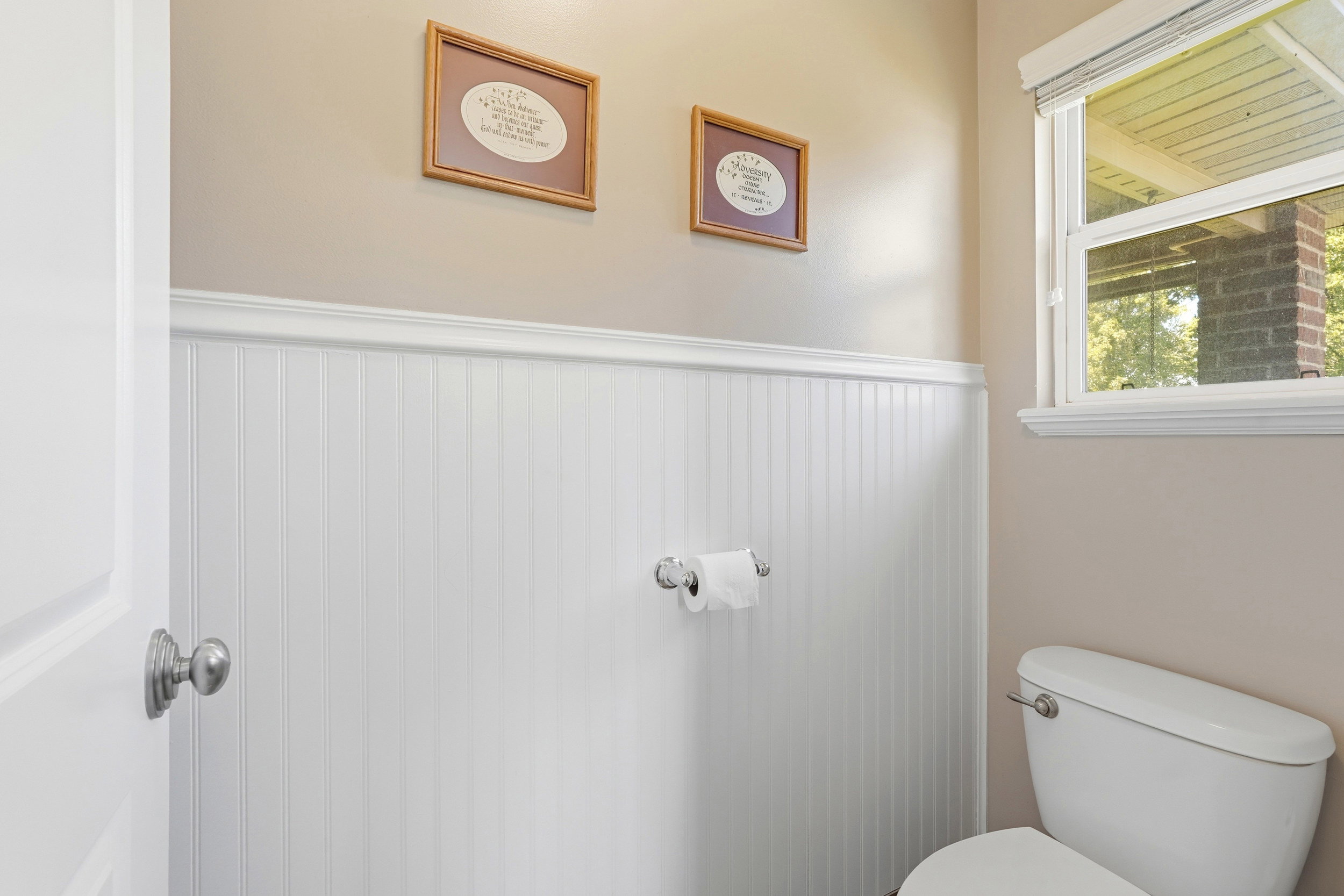 Bathroom featuring white beadboard wainscoting and coordinating trim