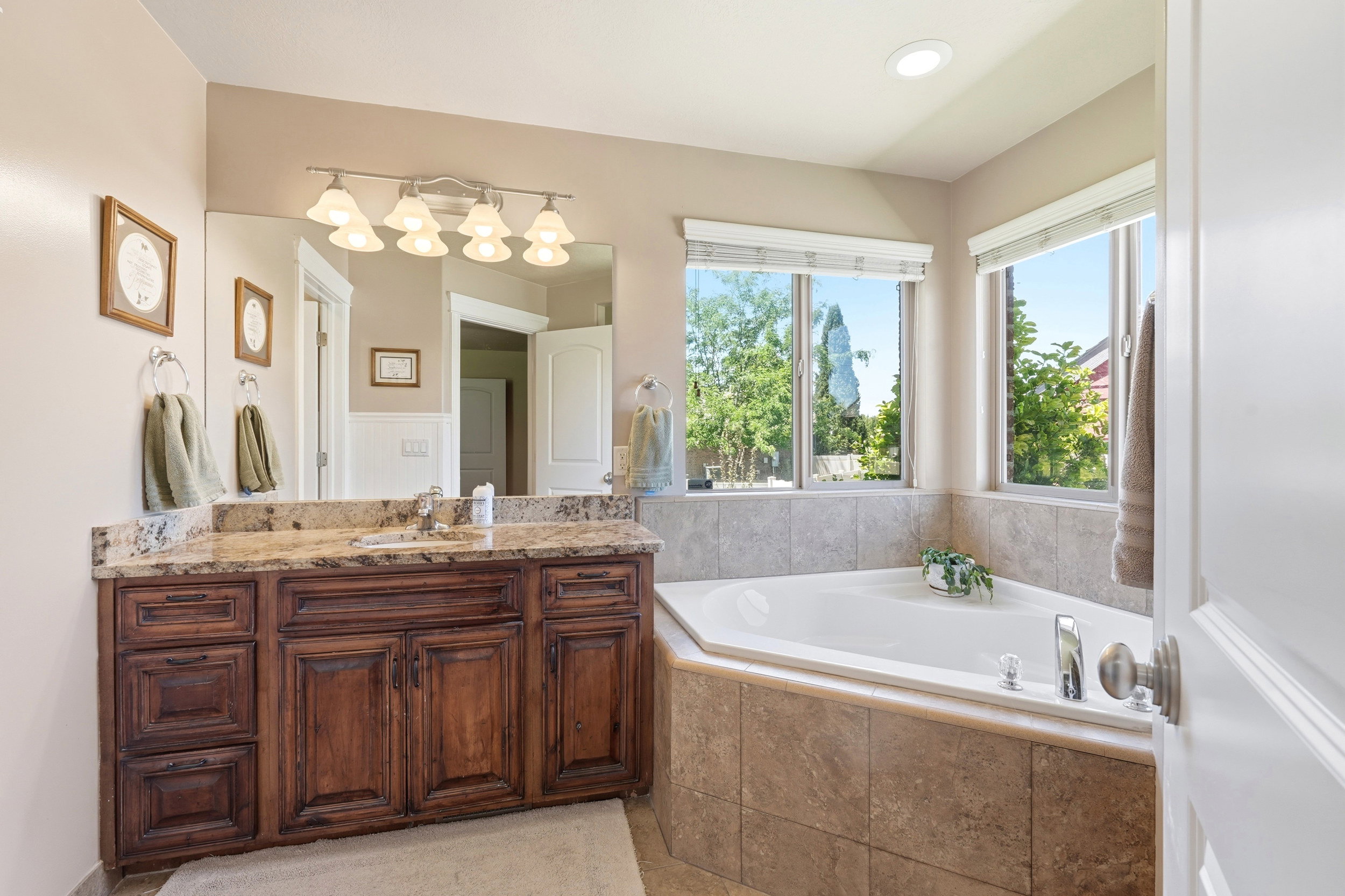 Custom cabinetry vanity with a granite countertop and undermount sink
