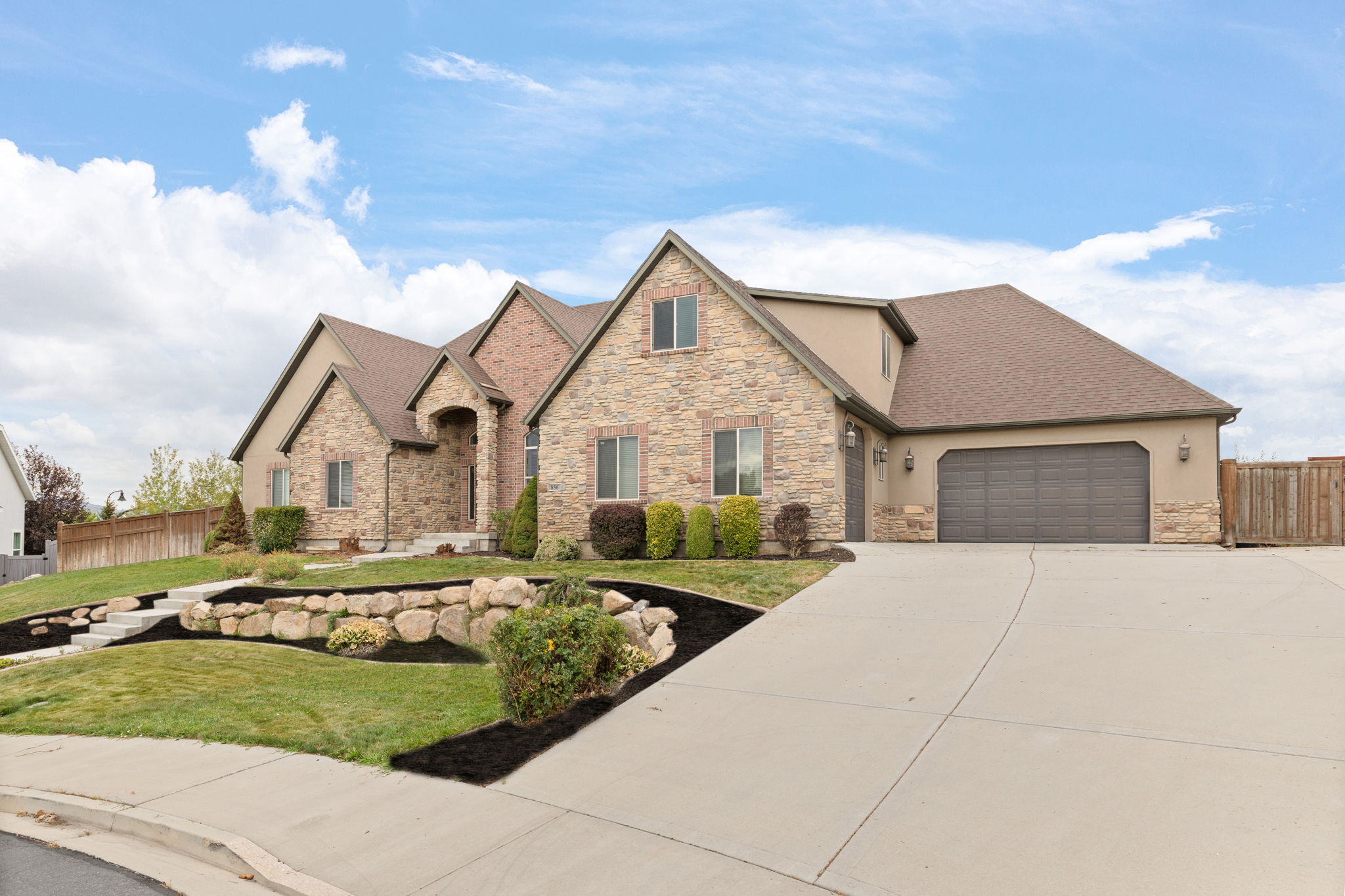 Stone and stucco exterior with multiple gables