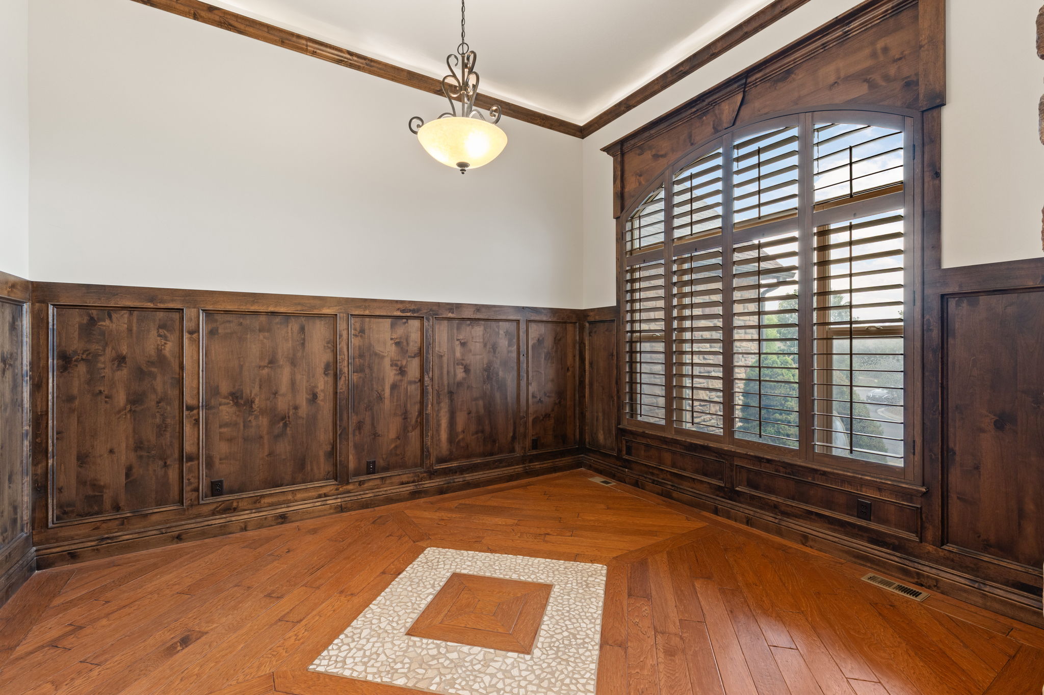 Arched window with plantation shutters