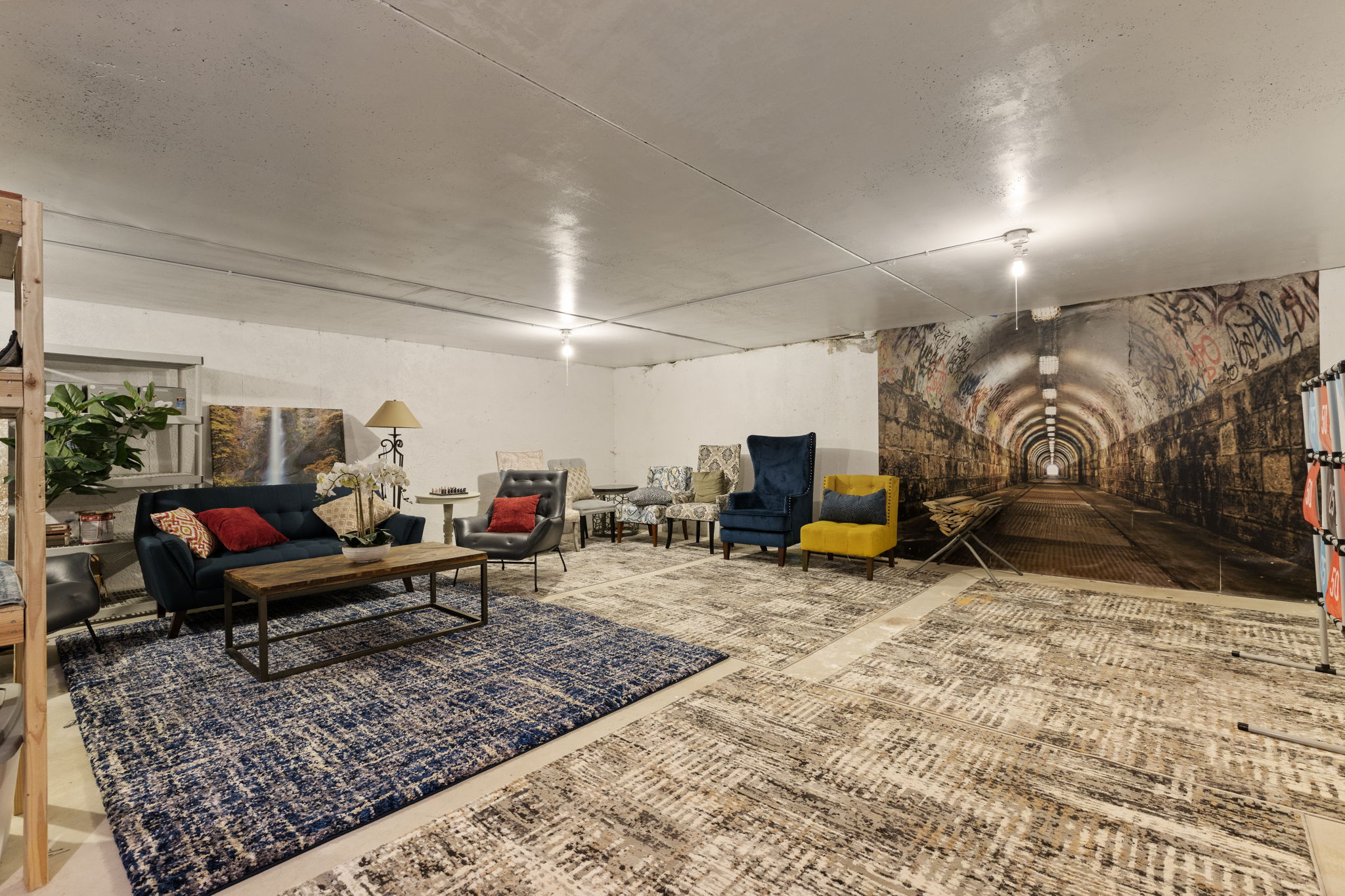 Spacious room with smooth ceiling, recessed lighting, and a large wall mural