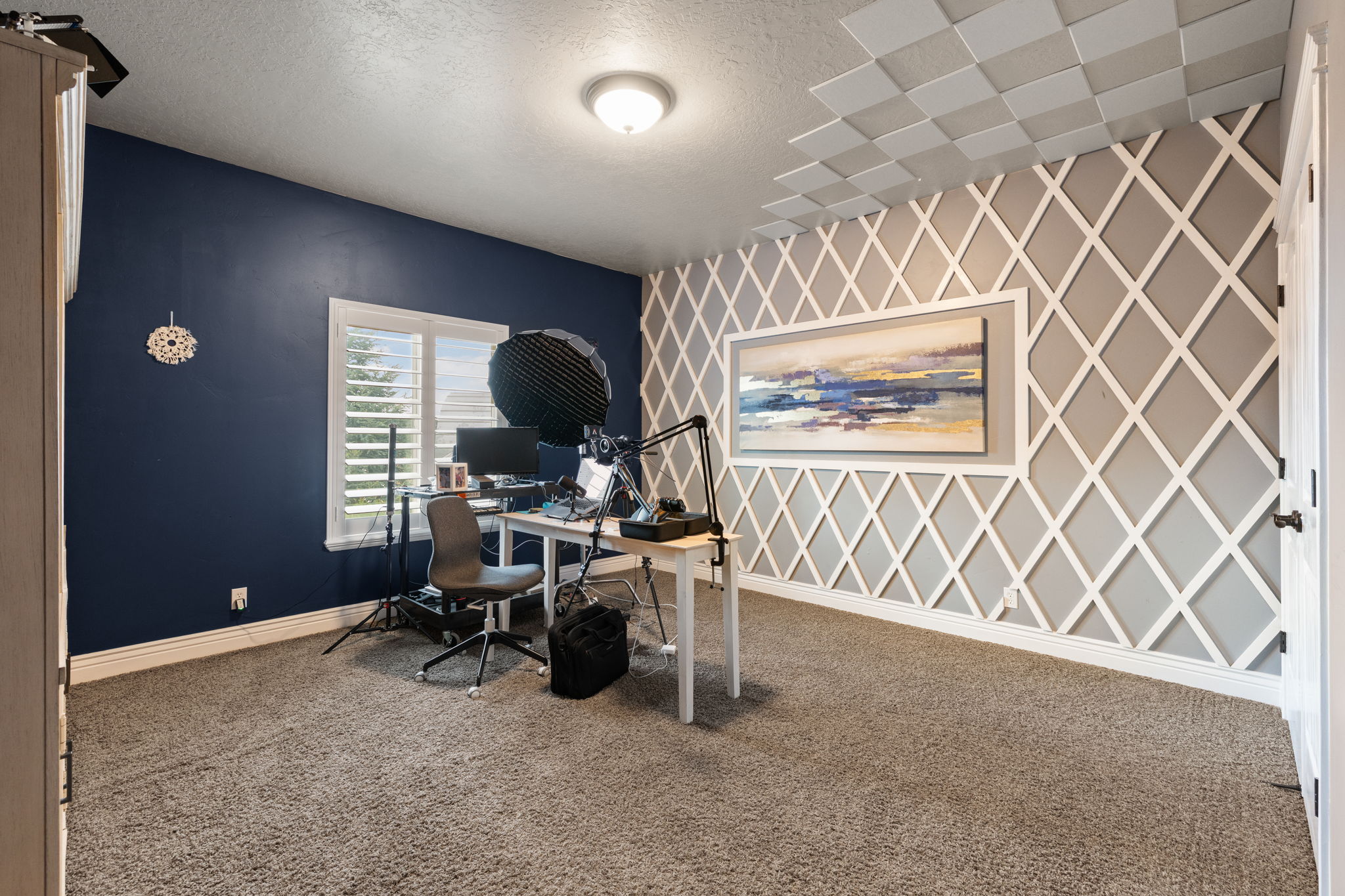 Room featuring decorative wall paneling, a recessed ceiling fixture, and carpet flooring