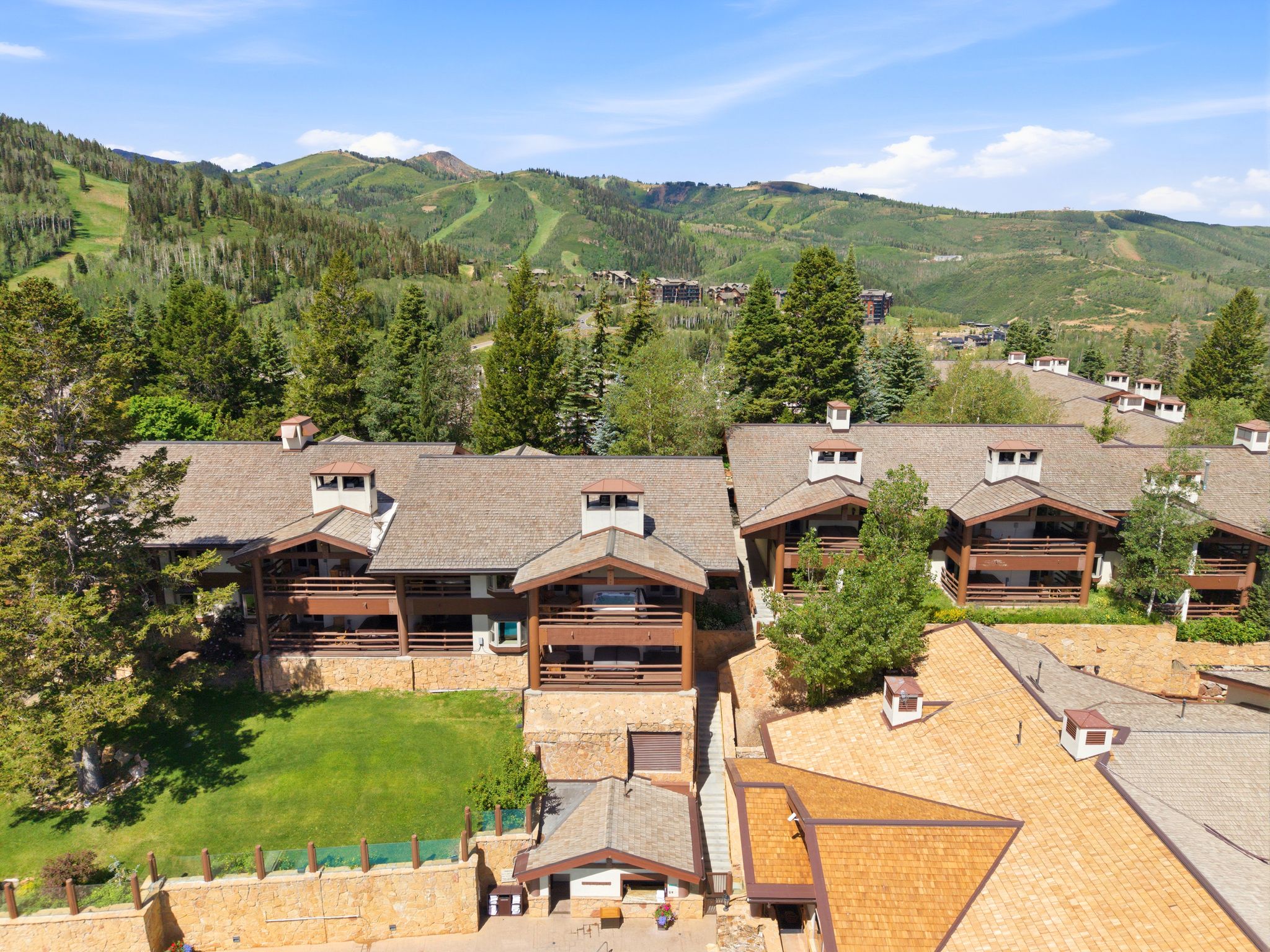 Multi-level mountain-style residence featuring a prominent pitched roof and multiple balconies