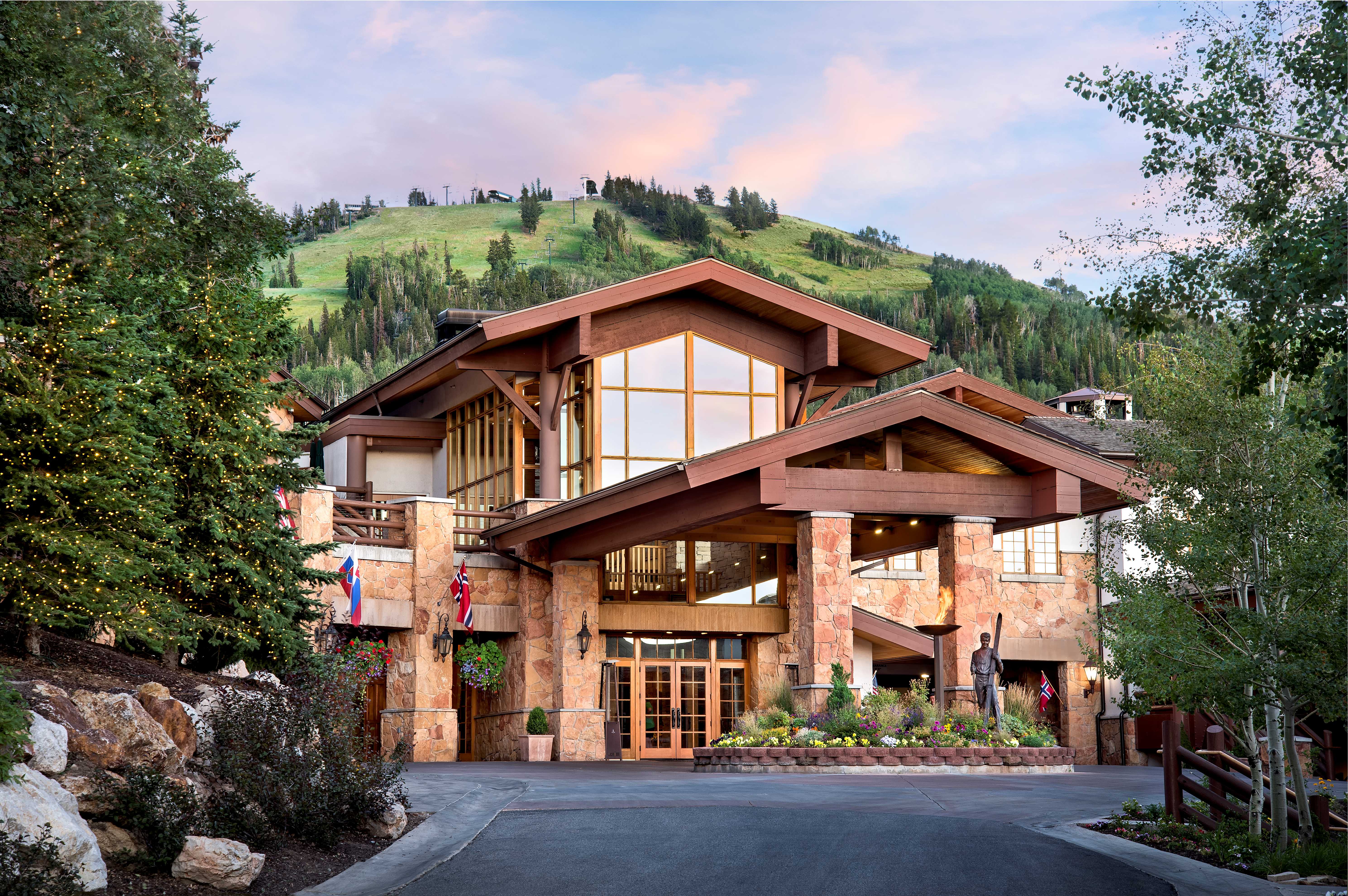 Mountain-style facade featuring natural stone and wood beam accents