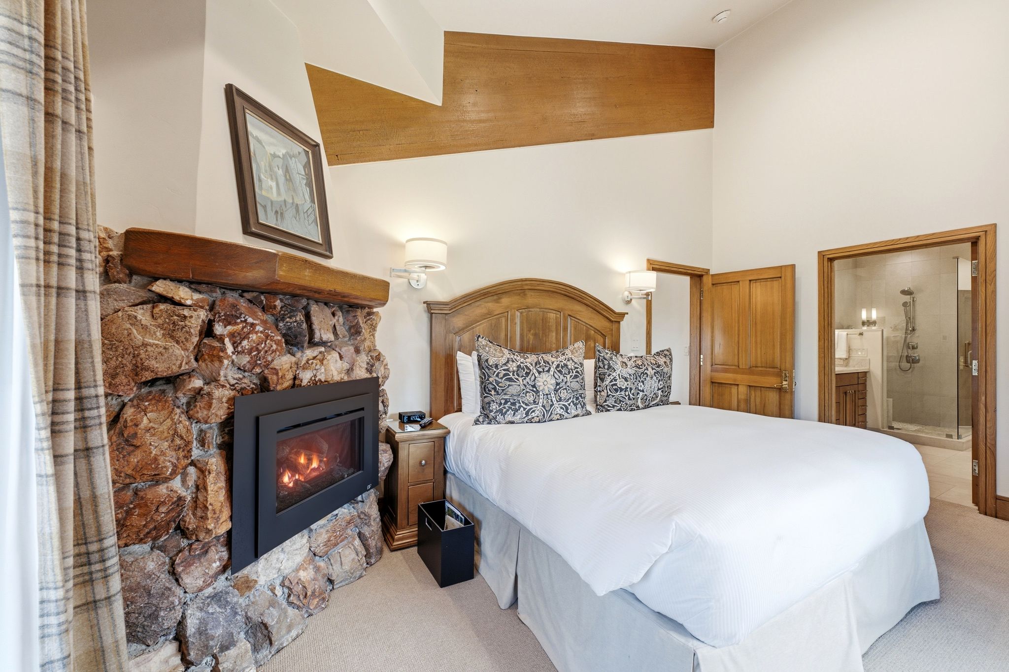 Stone-clad fireplace with wood mantle and integrated firebox