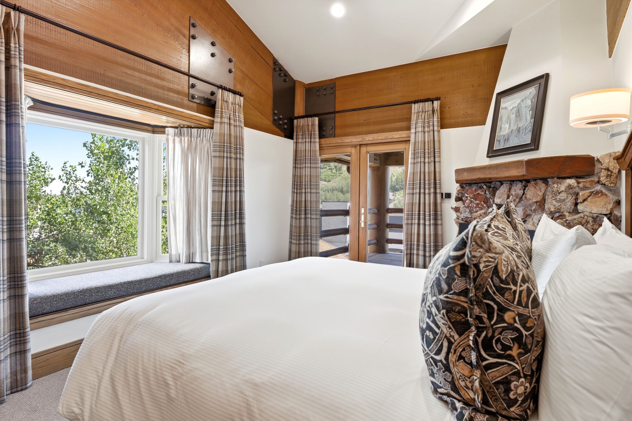 Vaulted ceiling with wood-finish paneling and exposed structural beams