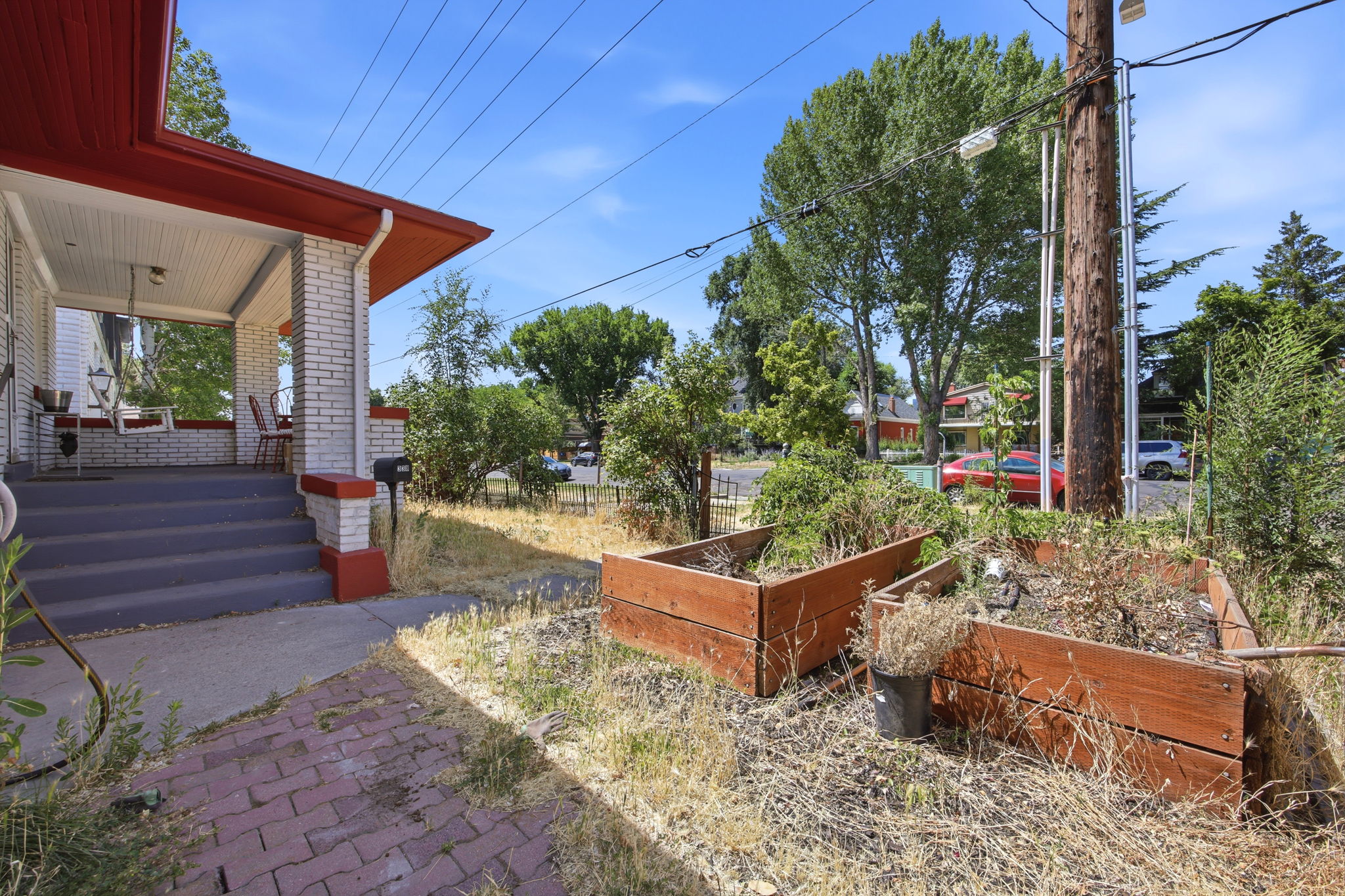 Front porch with painted concrete steps and white brick columns