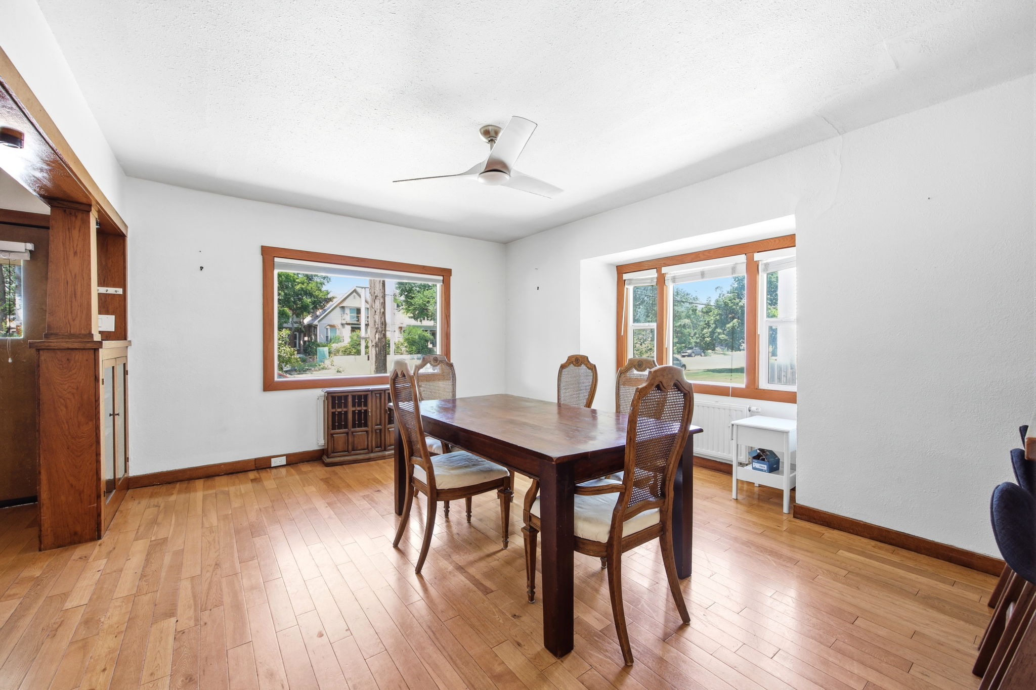 Hardwood flooring extending throughout, complemented by white walls and wood trim