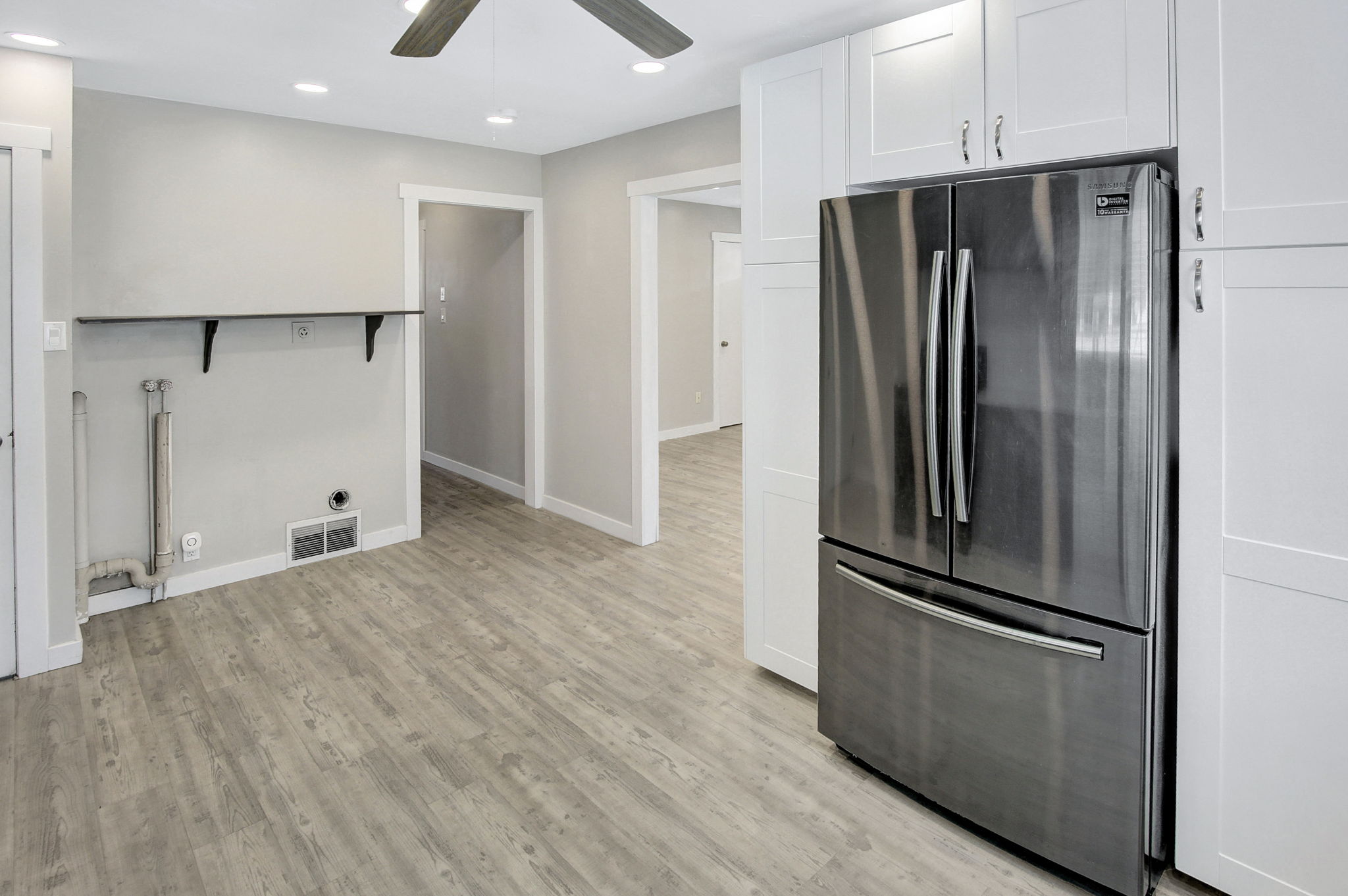 Modern kitchen space featuring a stainless steel French door refrigerator