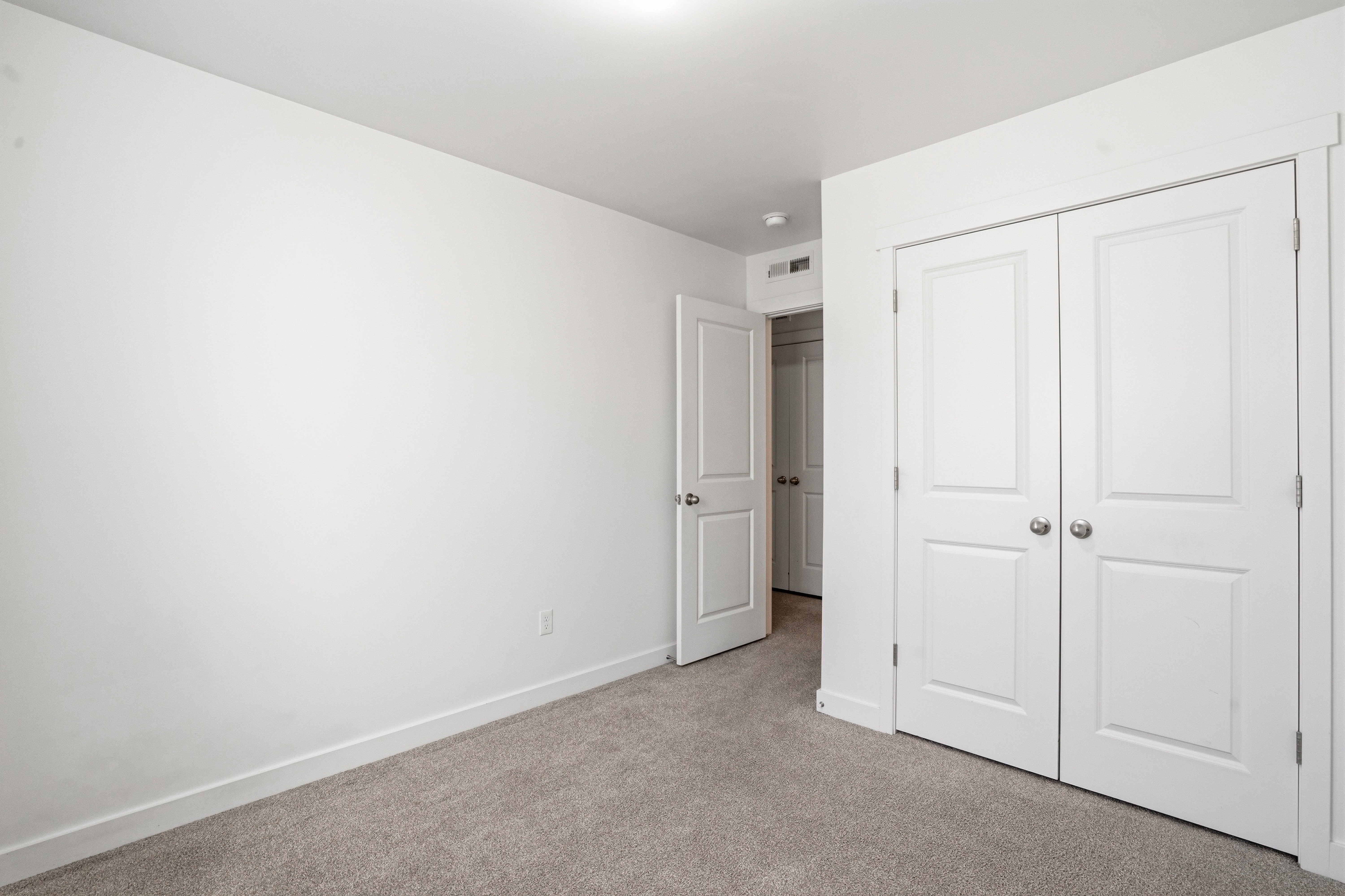 Neutral-toned carpeting paired with white walls