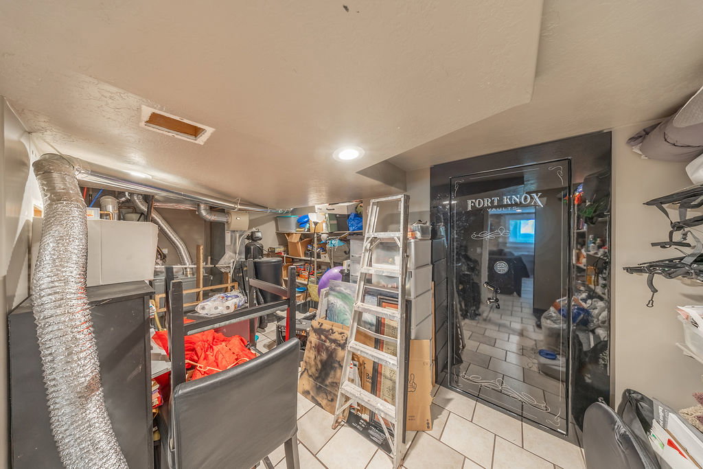 Utility area with tiled flooring and recessed lighting