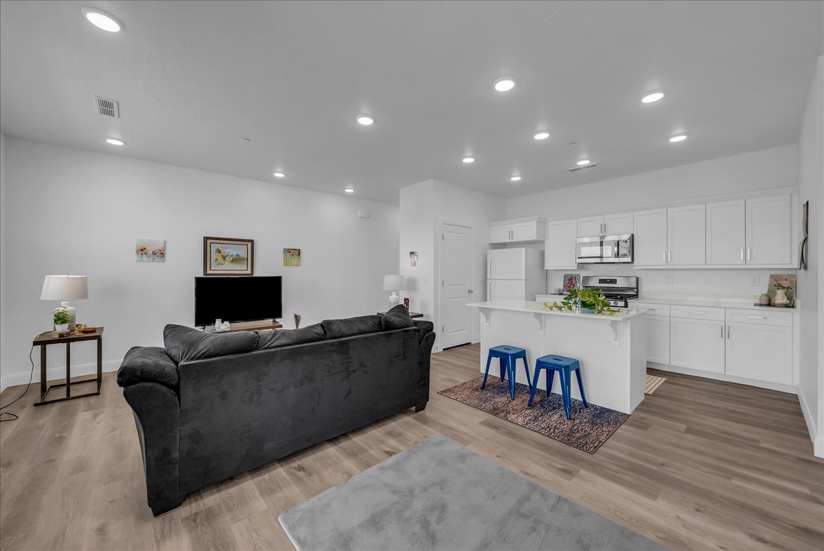 Open-concept living area with wood-finish flooring