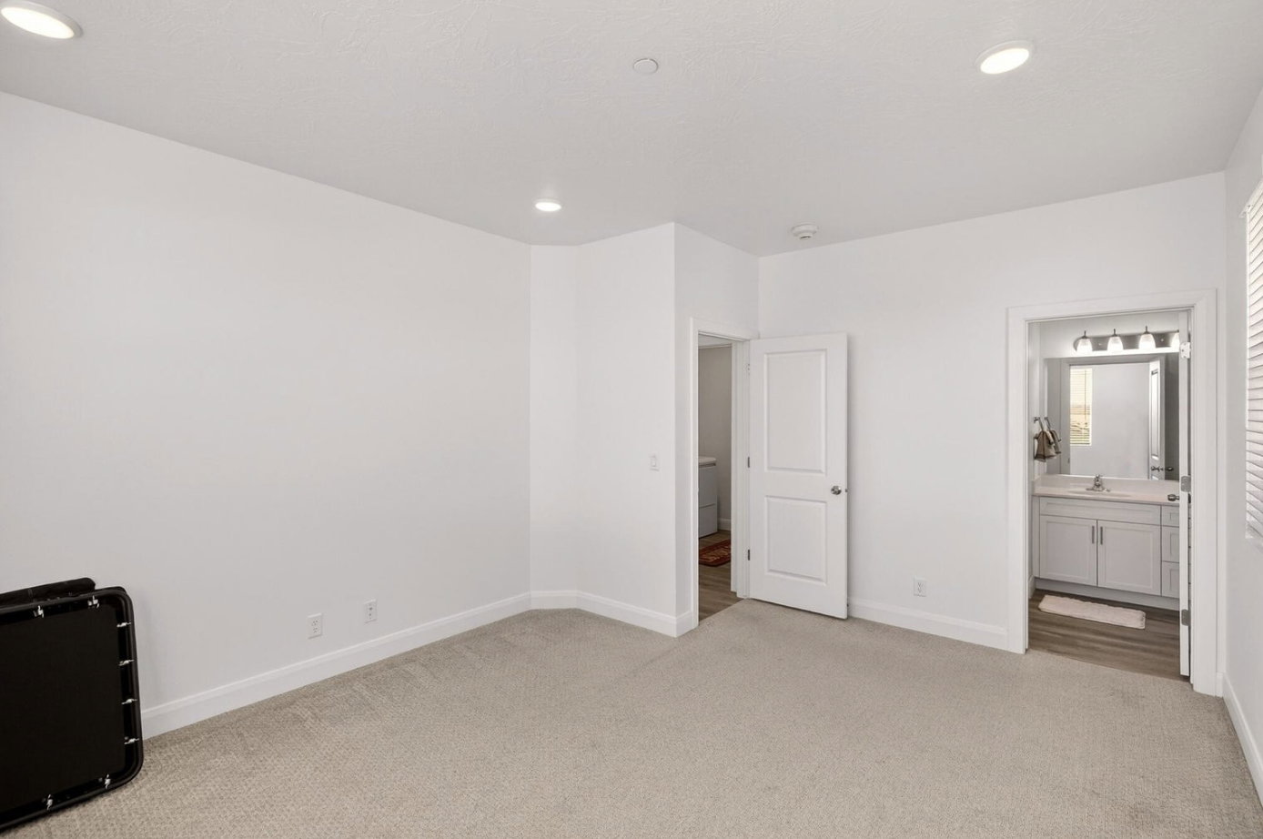 Carpeted room featuring recessed lighting and white baseboards