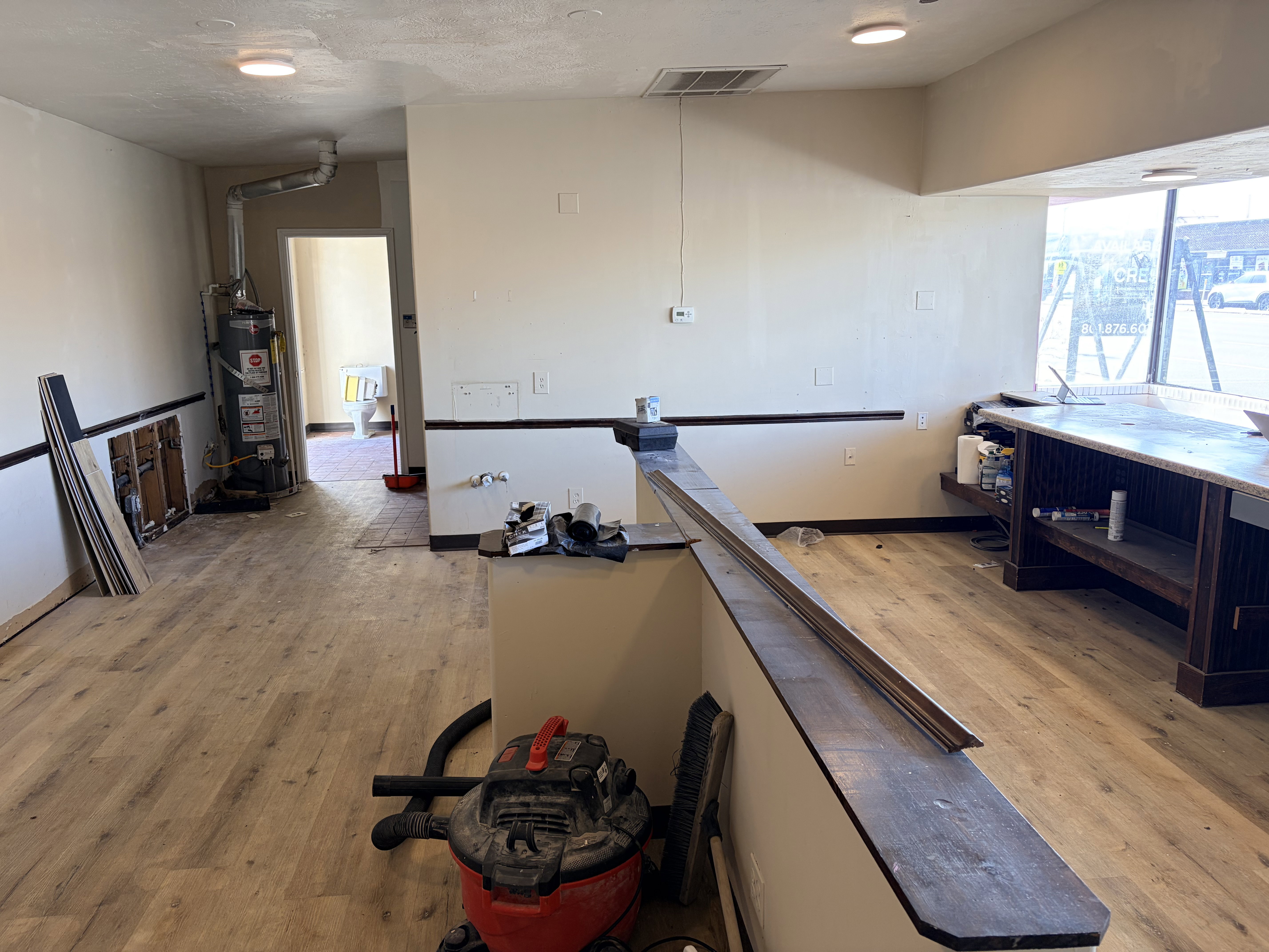 Interior commercial space featuring wood-finish flooring and neutral wall tones