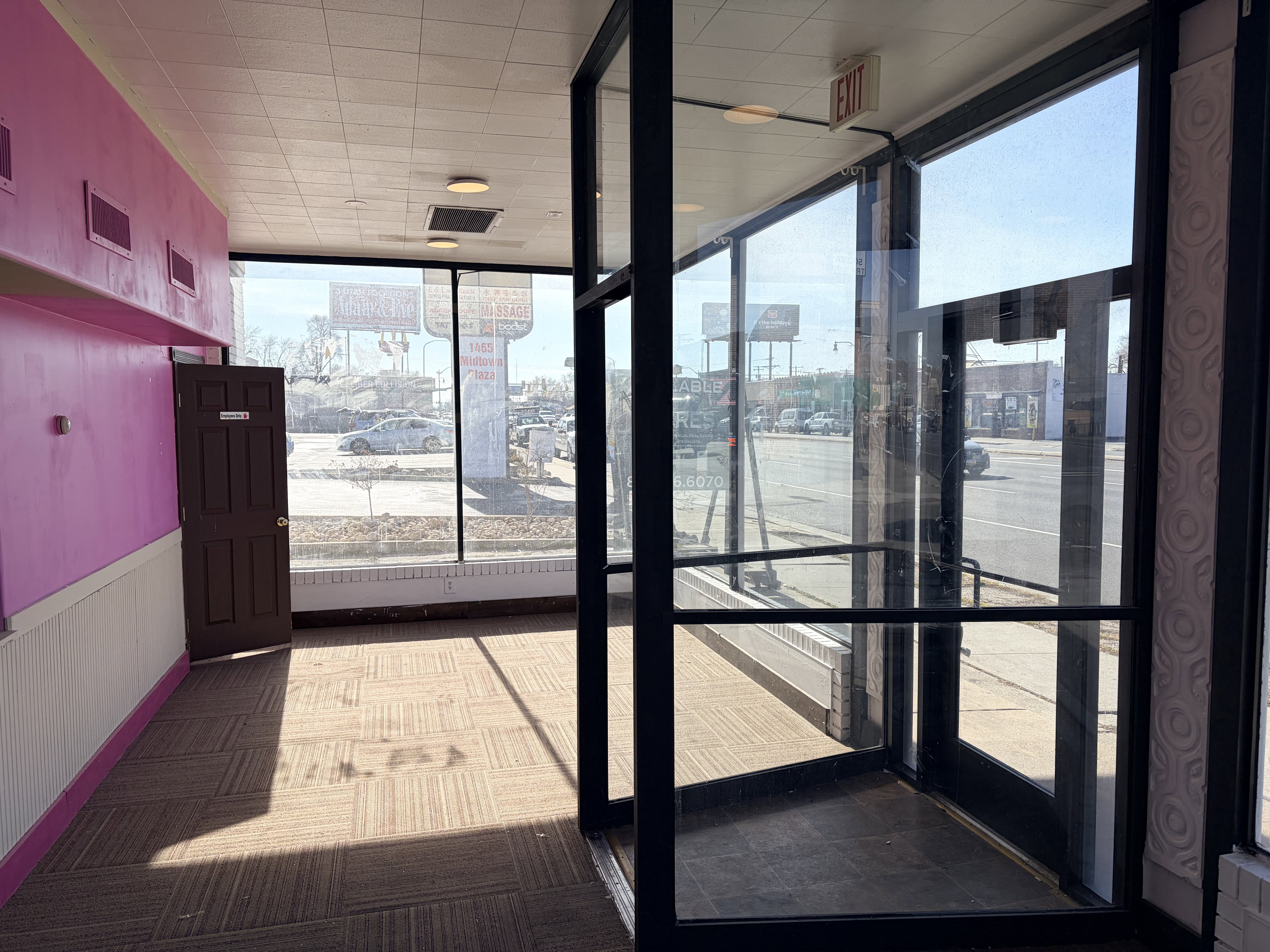 Expansive storefront windows offer significant street presence