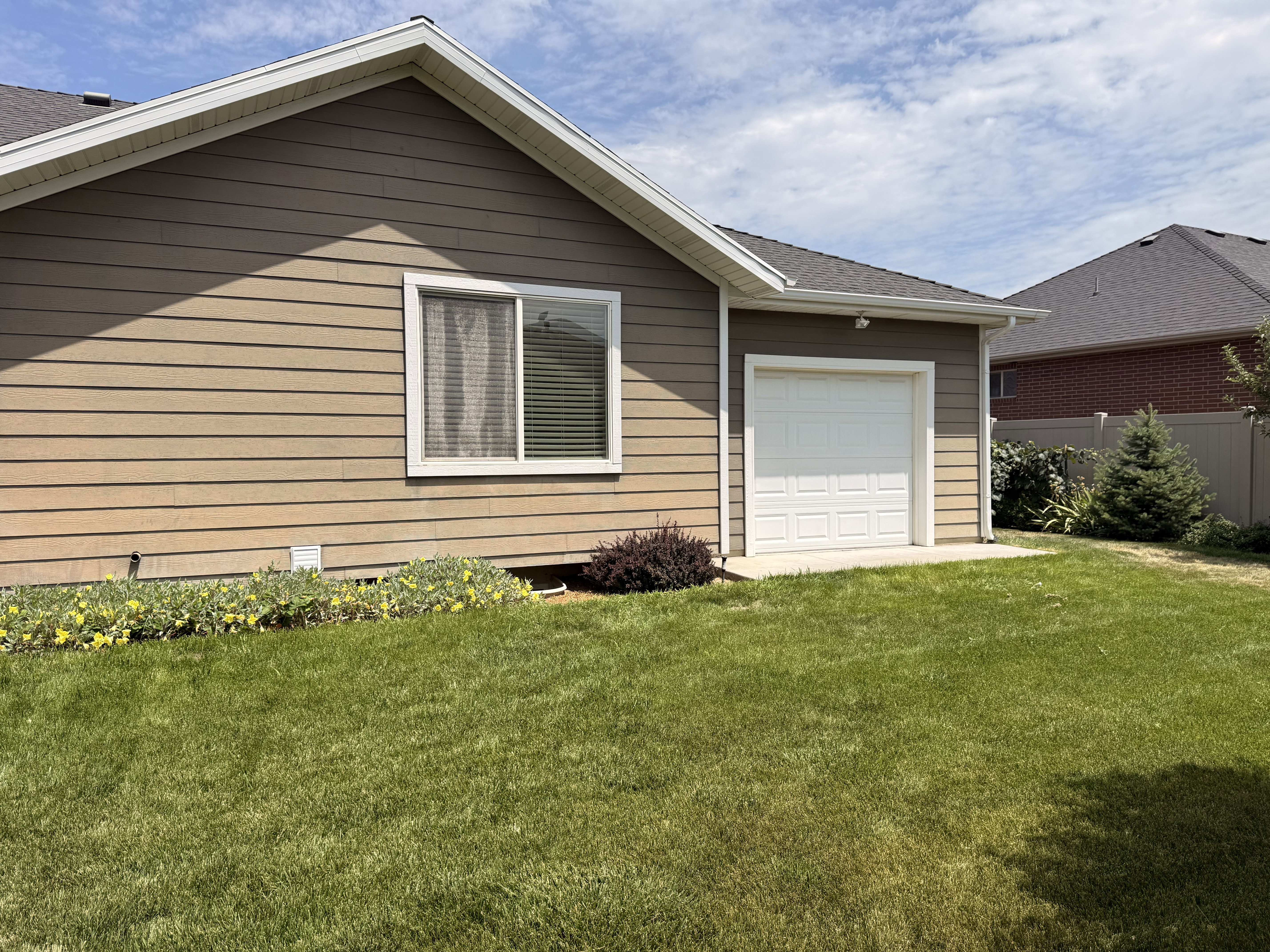 Attached single-car garage with a paneled door